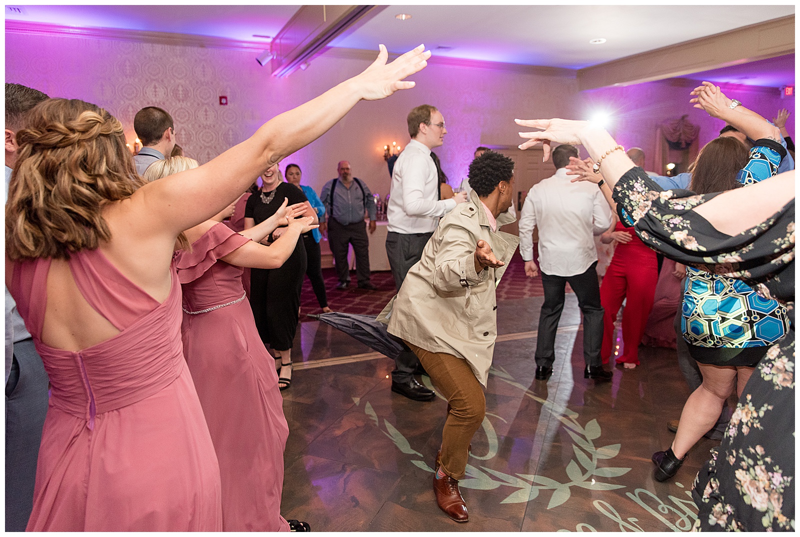 wedding guests celebrating and dancing on the dance floor during fun reception at willows at historic strasburg