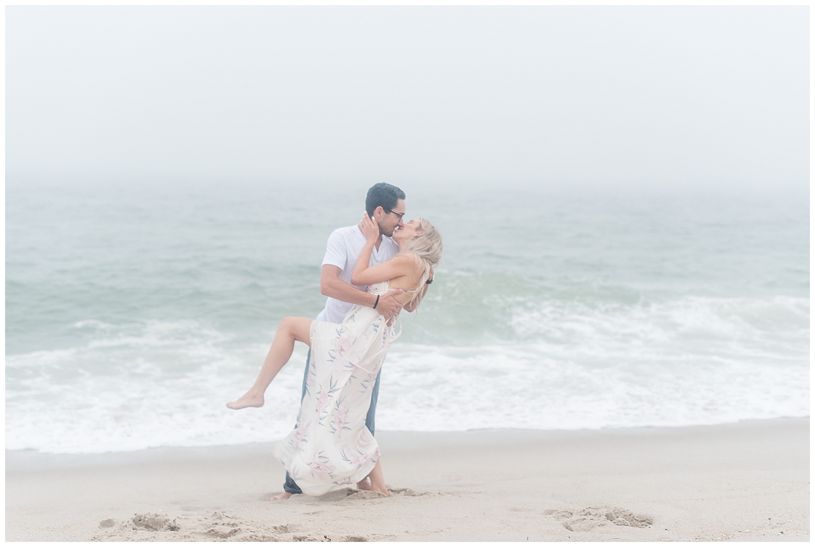 standing along the ocean guy holds girl and dips her back kissing her in bayhead new jersey