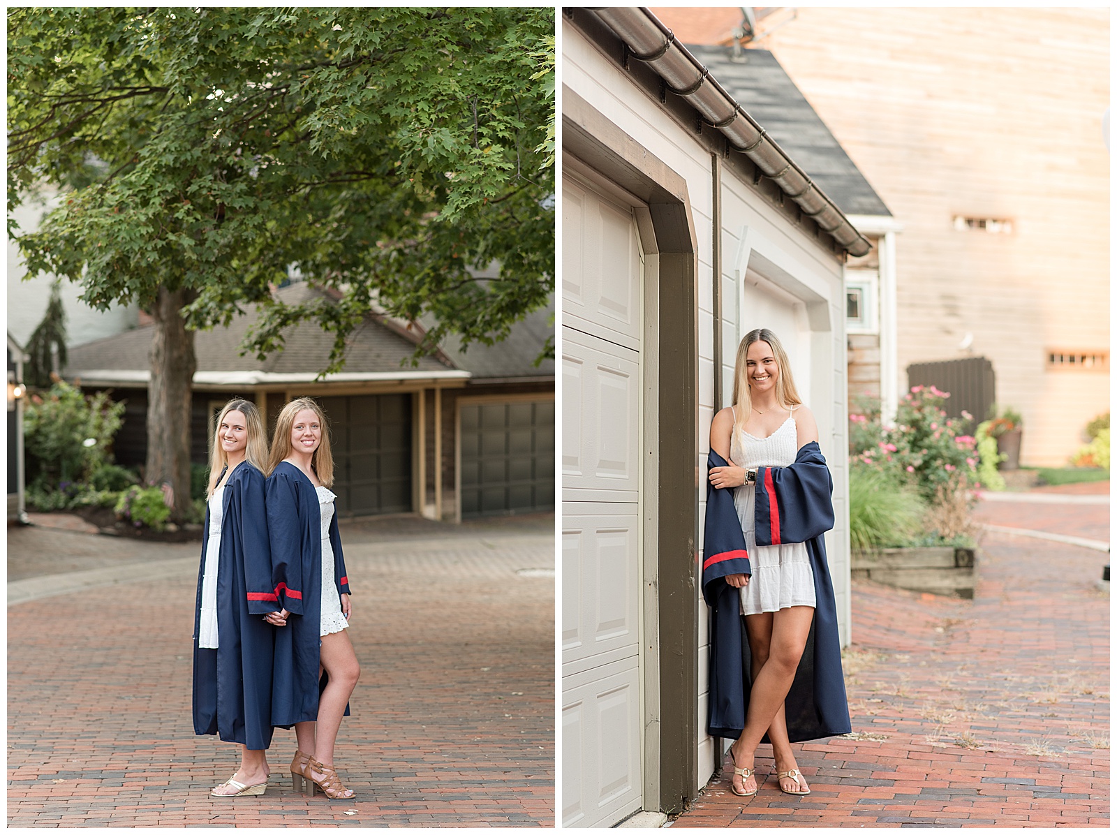 two senior girls in navy blue graduation gowns stand back-to-back and smile at camera on brick road under tree