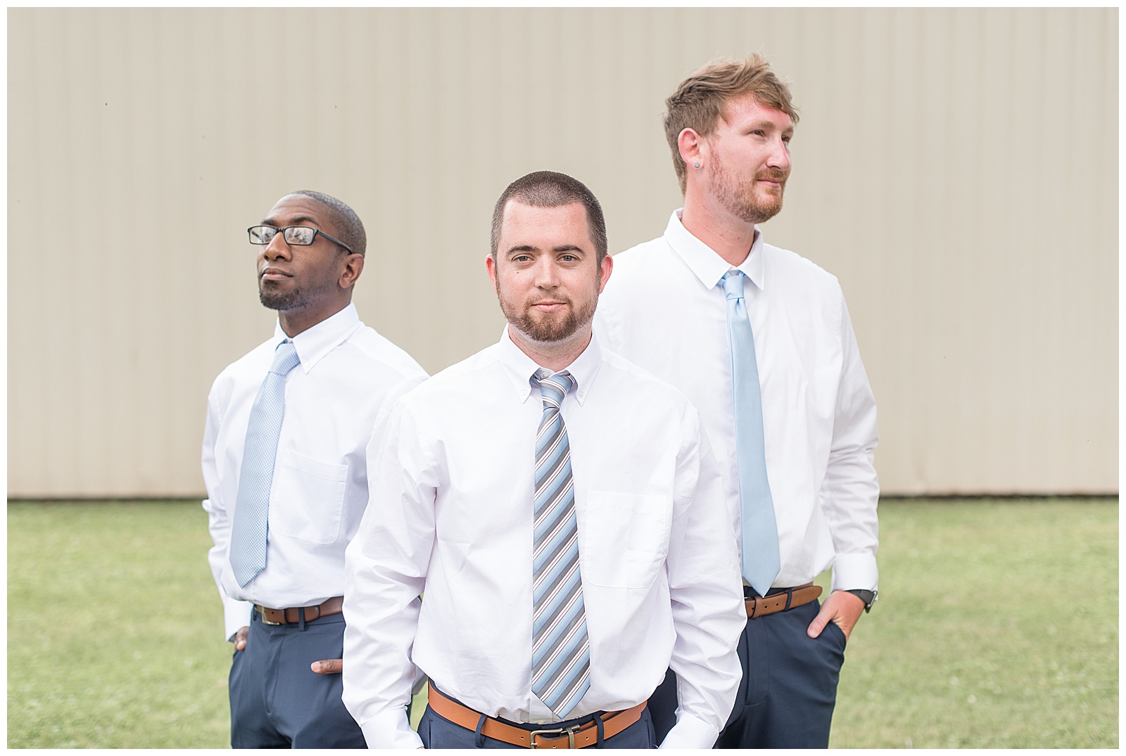 groomsmen photos in front of tan shed