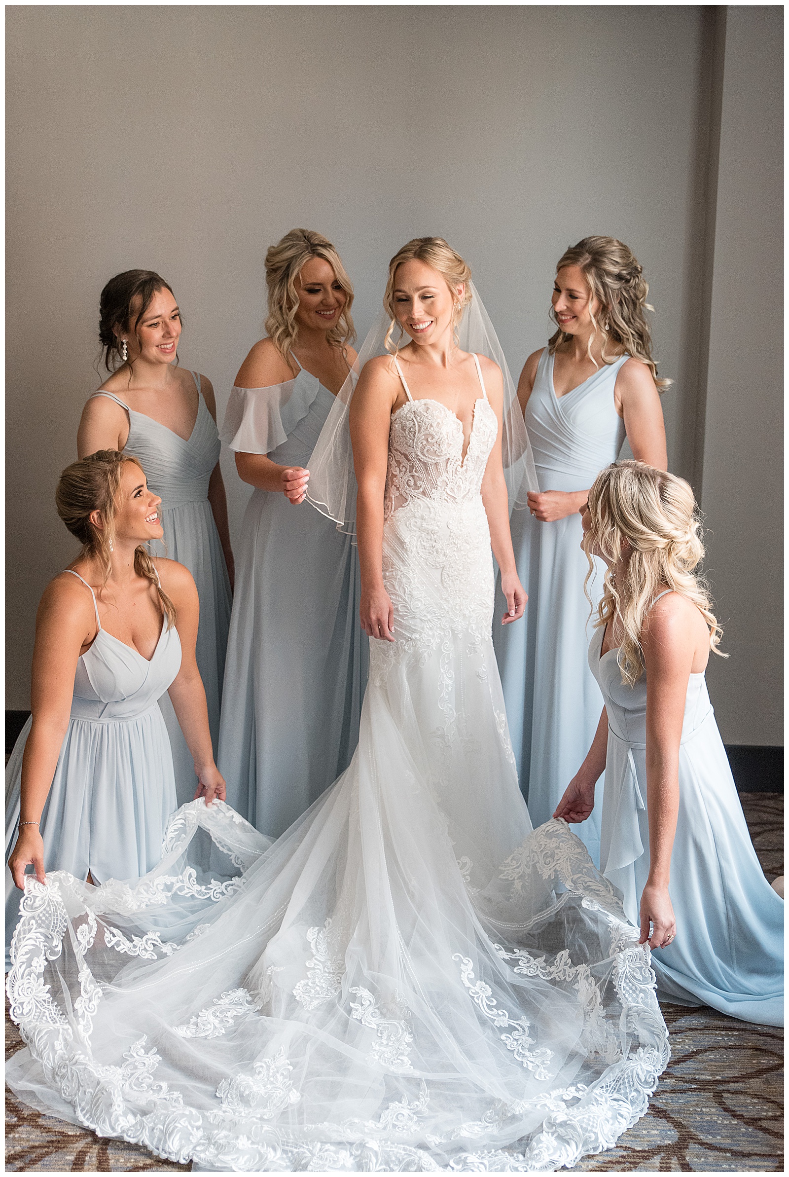 bride in white gown and veil surrounded by five bridesmaids in light blue gowns in lancaster pennsylvania
