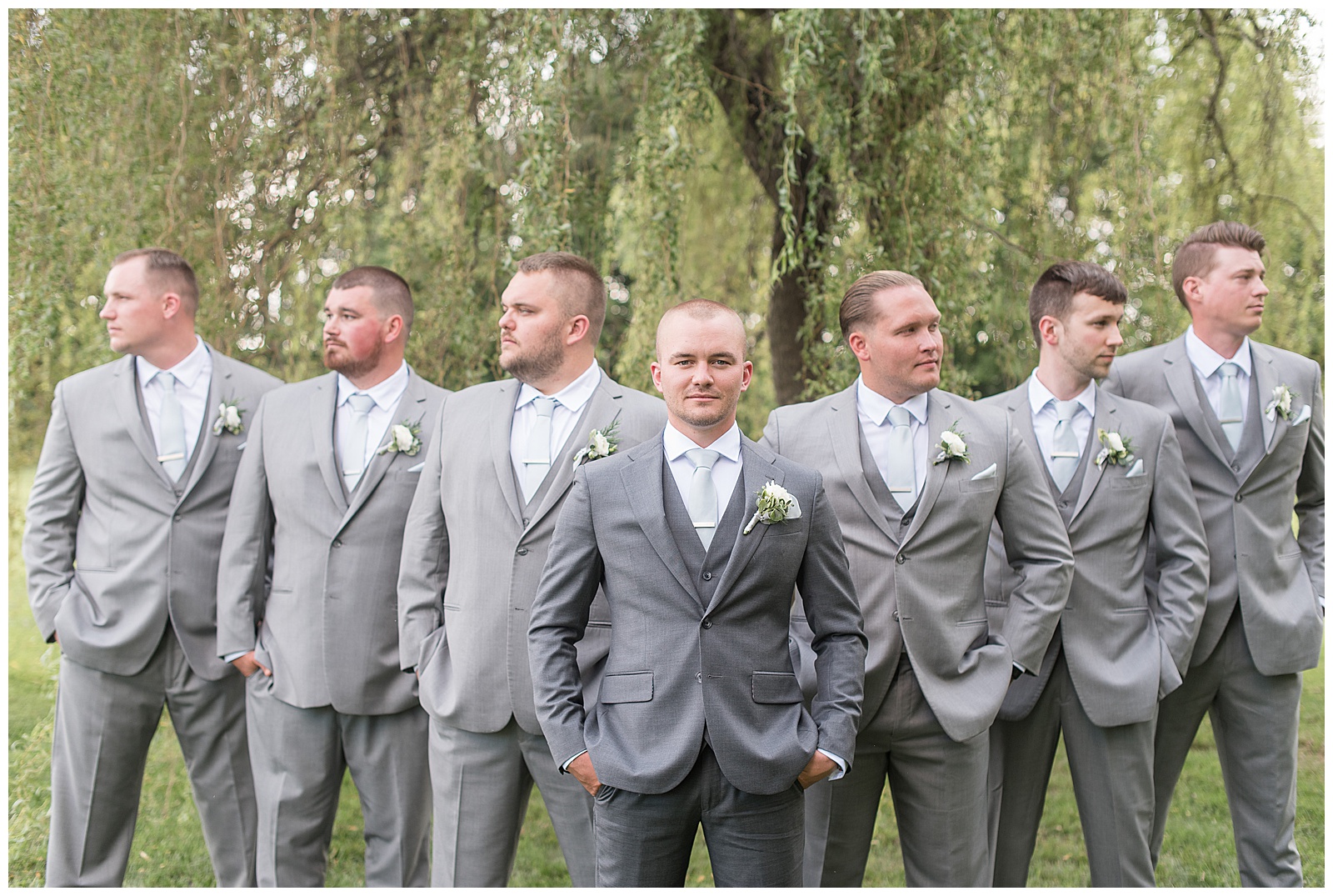 groom looking at camera with groomsmen behind him looking to the left and right in lancaster pennsylvania