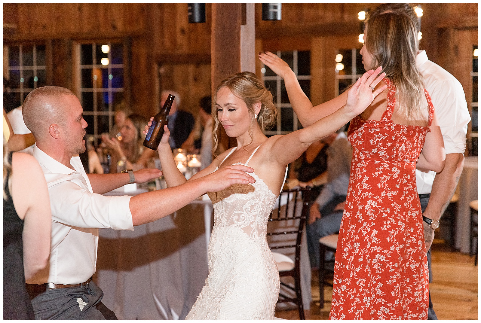 bride dancing with her friends and family during barn wedding reception at the barn at silverstone