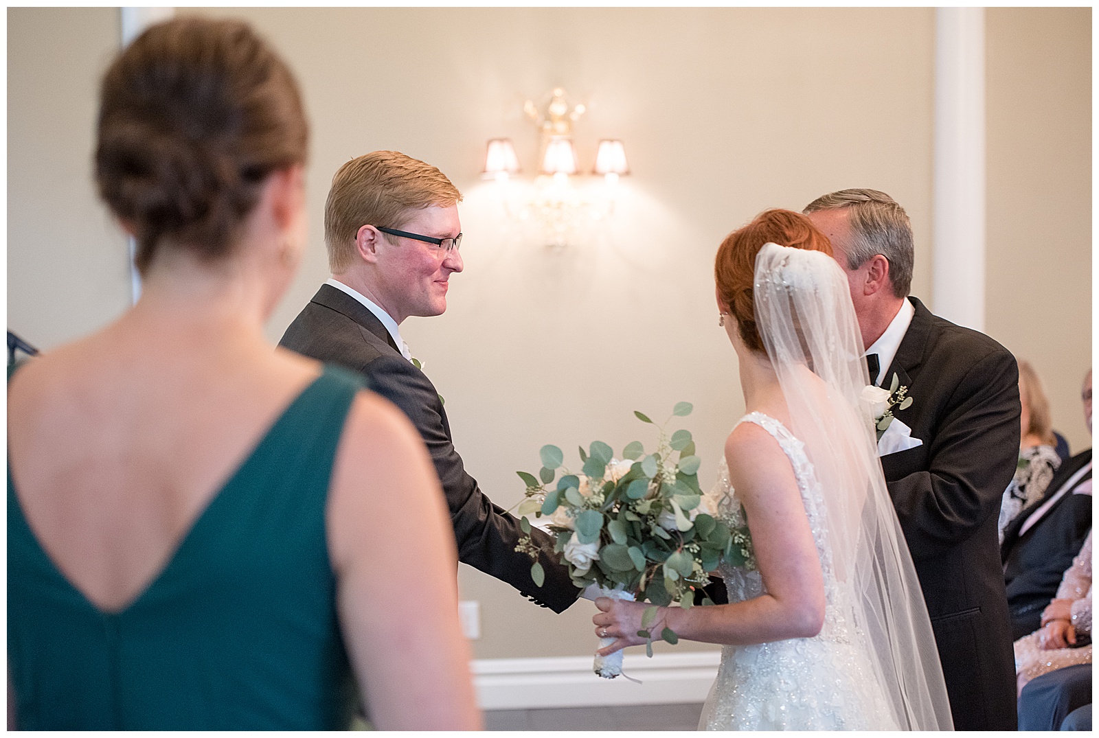 bride's father handing her over to her groom during wedding ceremony at cameron estate inn in lancaster pennsylvania