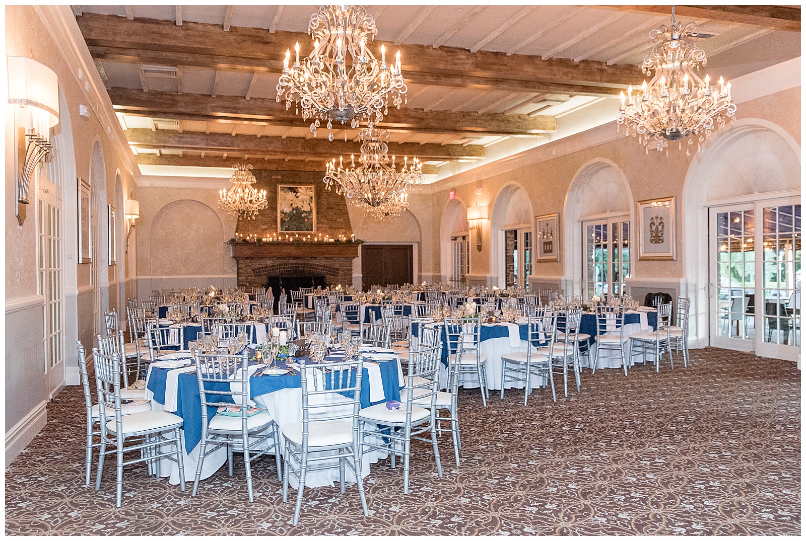 tables with white and blue linens and chairs all set up for beautiful wedding reception inside north jersey country club
