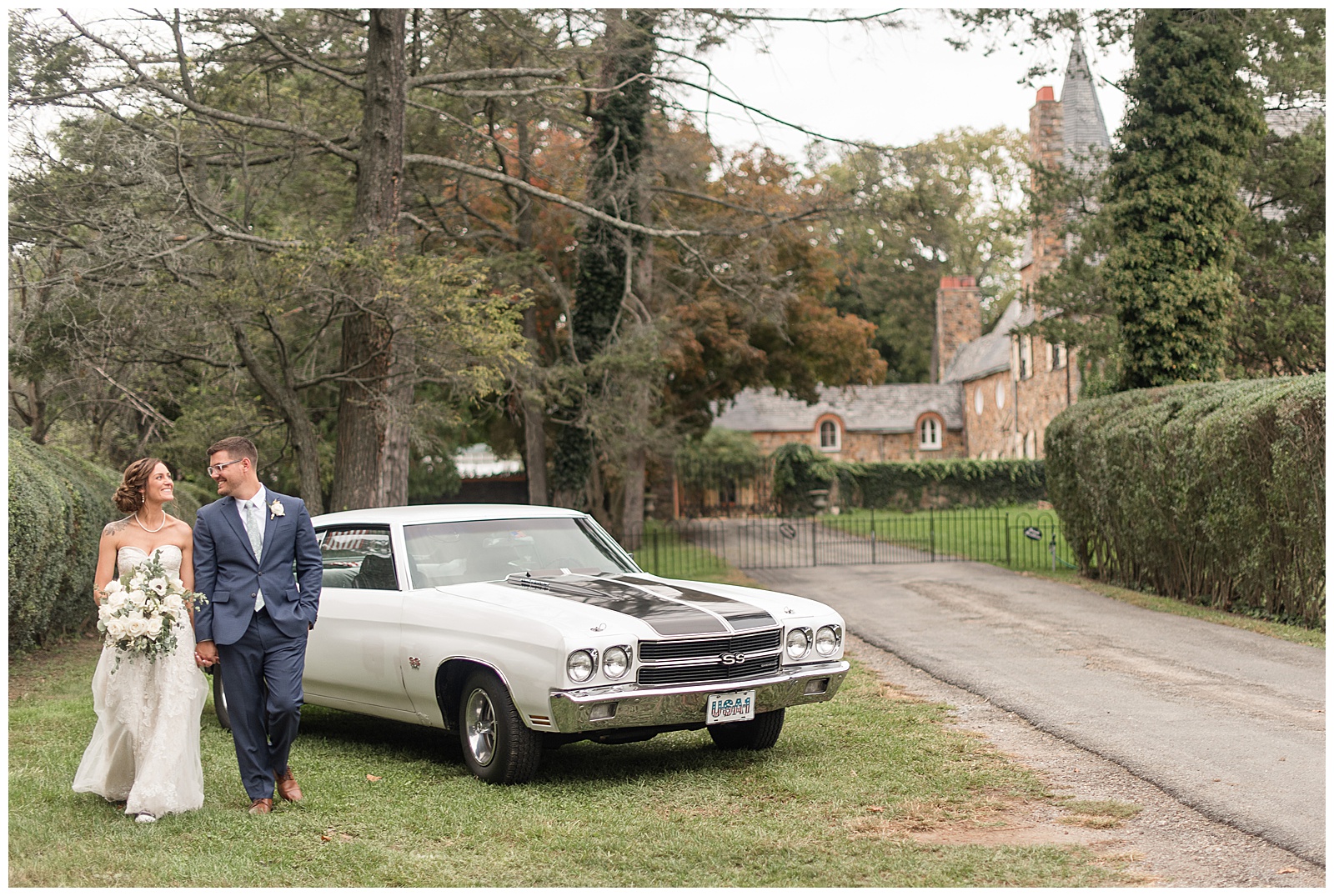 bride and groom walking towards camera looking at each other with antique car behind them at lauxmont farms