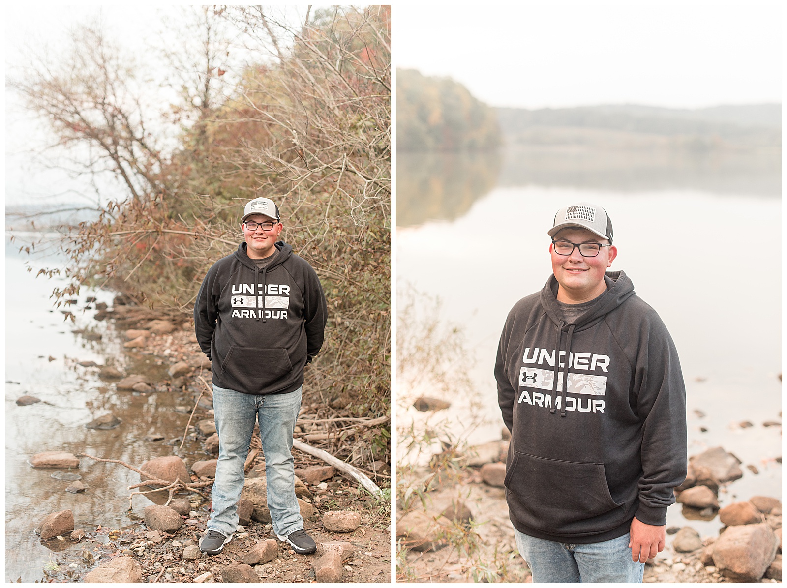 senior guy wearing black under armour hoodie and blue jeans with baseball hat standing on rocks by water on cloudy day