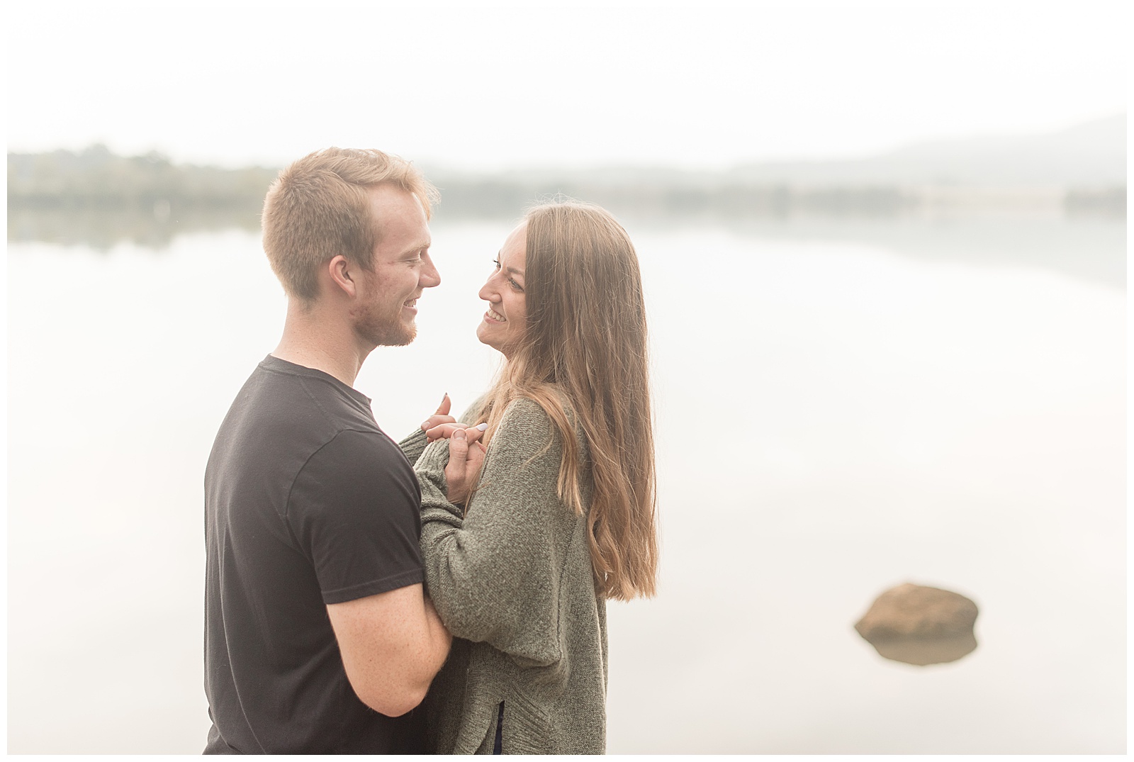 engaged couple hugging with guy wearing black t-shirt and jeans and girl wearing oversized army green shirt with jeans at middle creek wildlife