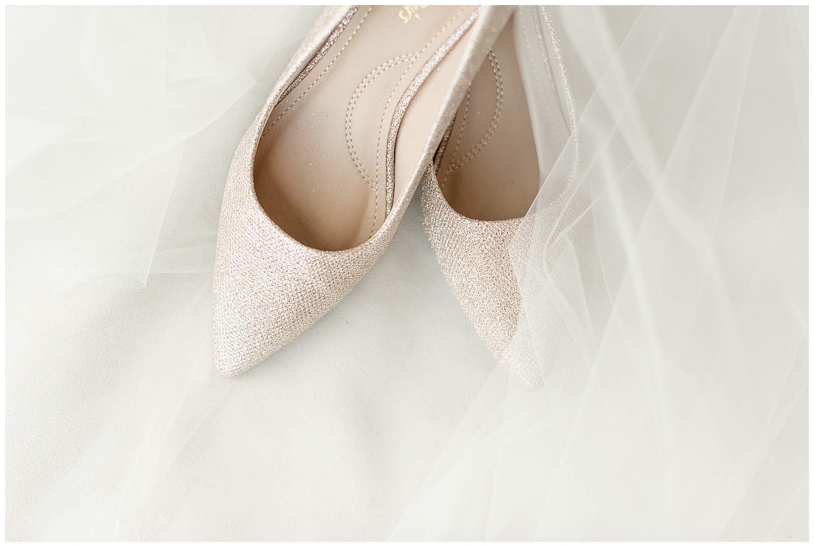 bride's high heels surrounded by the tulle of her white wedding veil at folino estate in kutztown pennsylvania