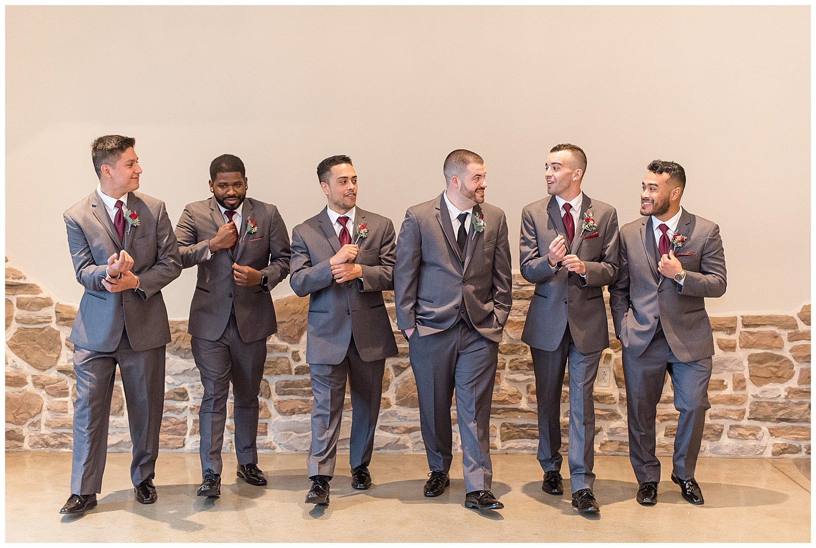 groom and his groomsmen all looking at each other casually walking towards camera inside folino estate in kutztown pennsylvania