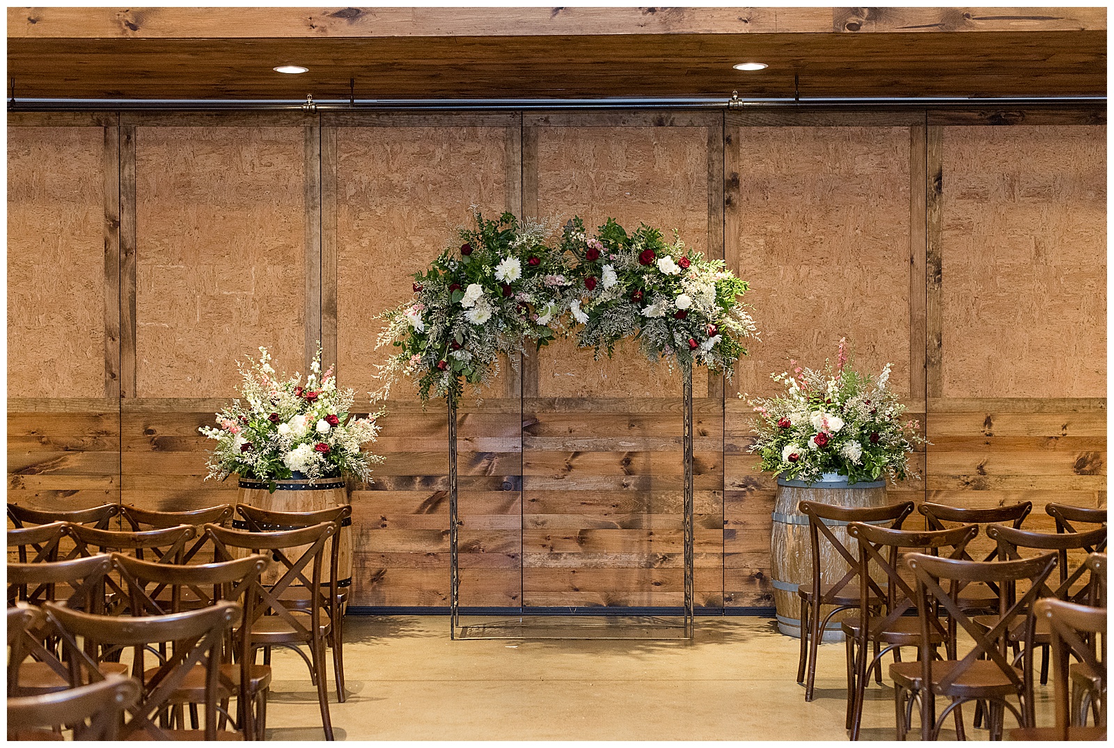 beautifully decorated wedding ceremony with chairs set up and floral archway and large floral bouquets at folino estate