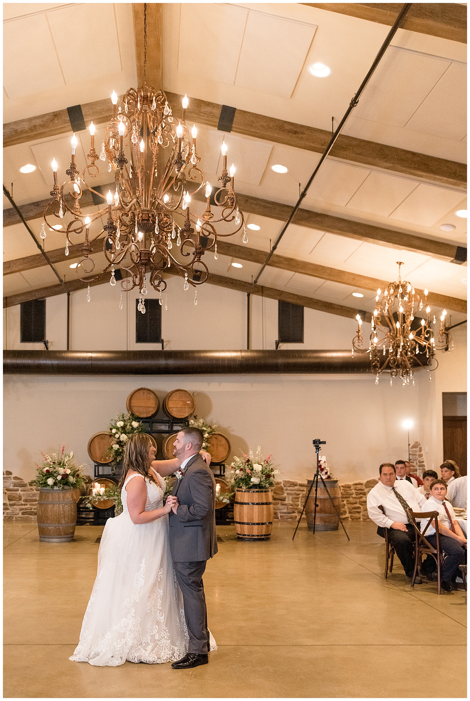 couple shares their first dance as husband and wife inside beautiful reception at folino estate as guests are seated and watching them