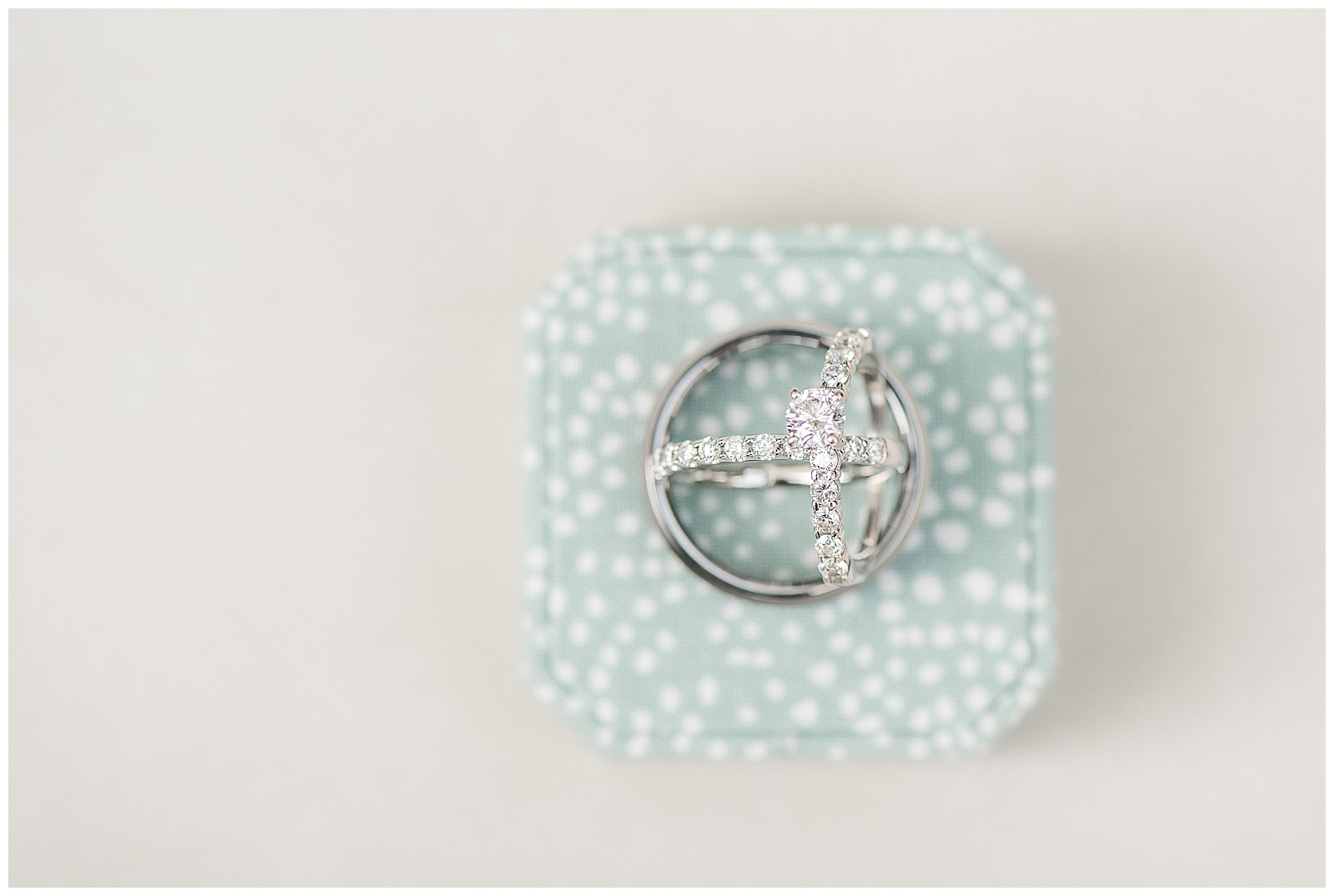silver wedding rings displayed atop mint green with small white polka dots jewelry box in collegeville pennsylvania