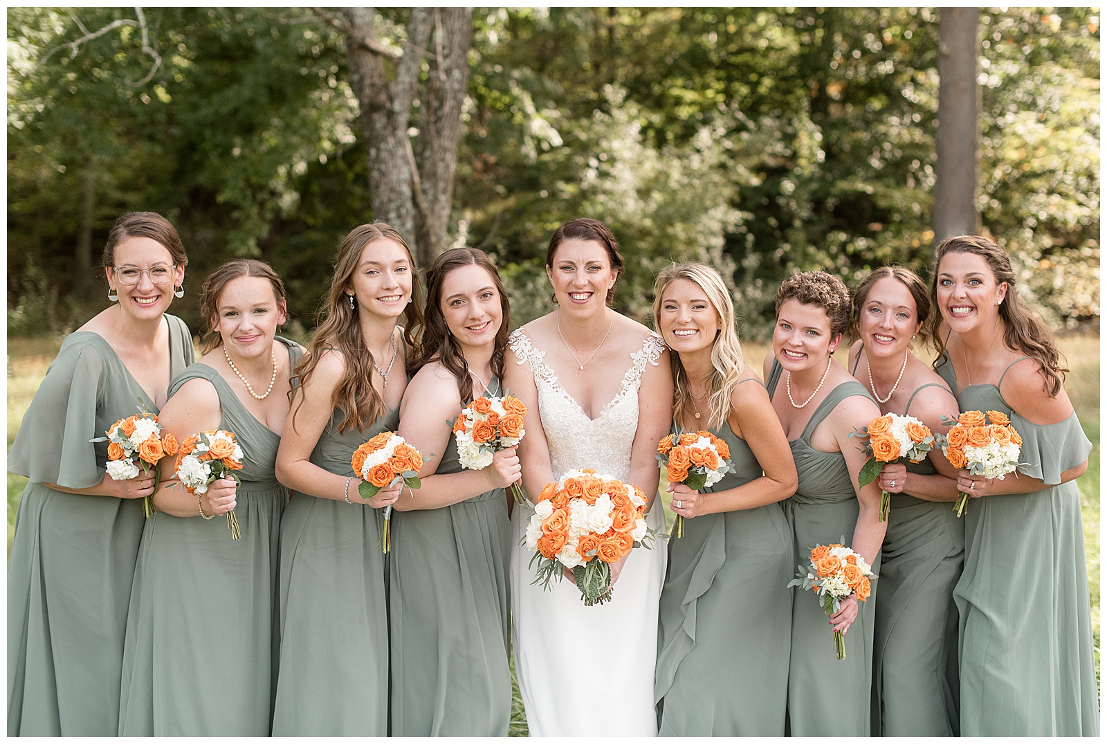 bride and bridesmaids all leaning in towards camera holding bouquets on sunny fall day outdoors in eastern pennsylvania