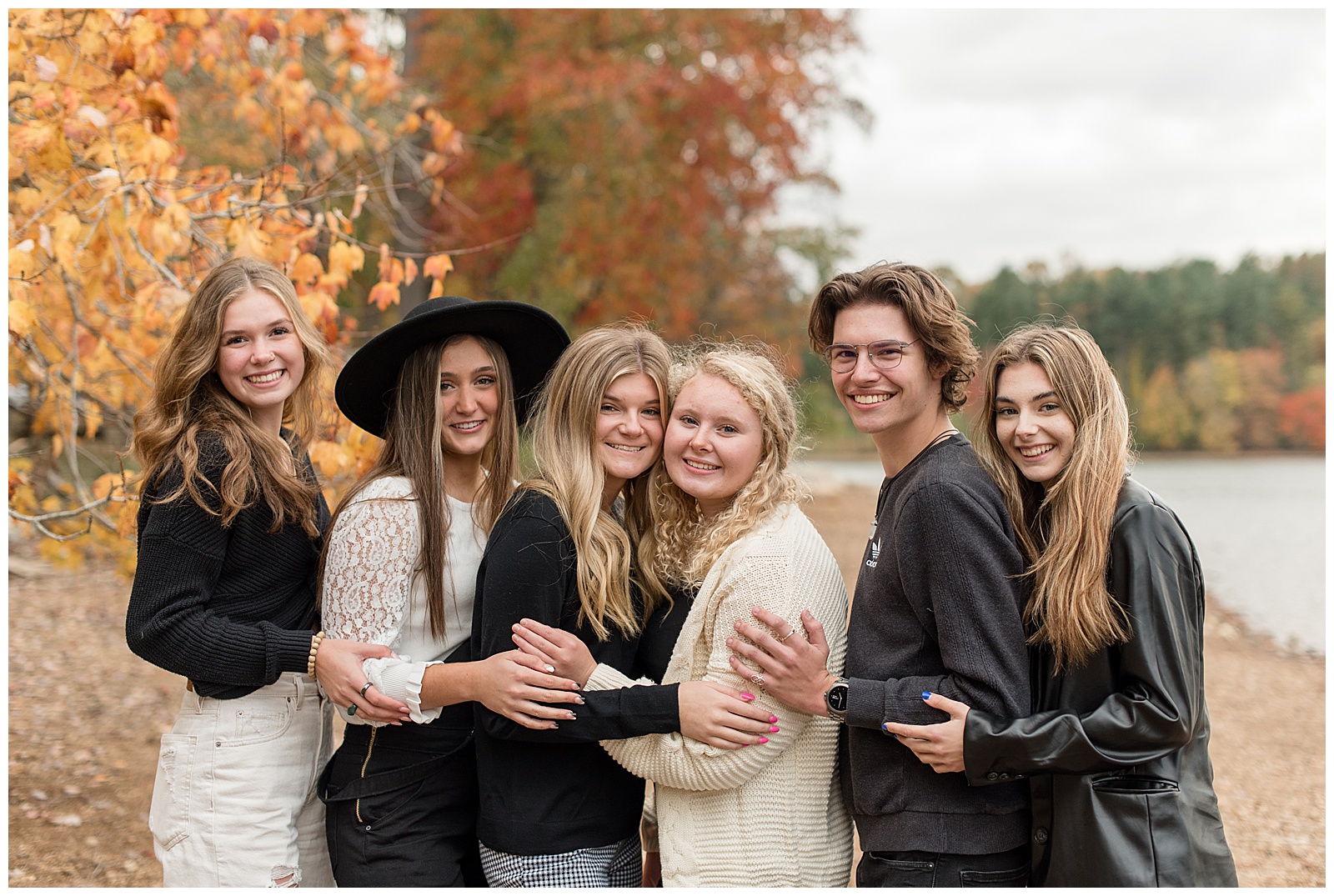 close up of six class of 2022 senior spokesmodels standing close with their hands resting on the person beside them's arm at reservoir park