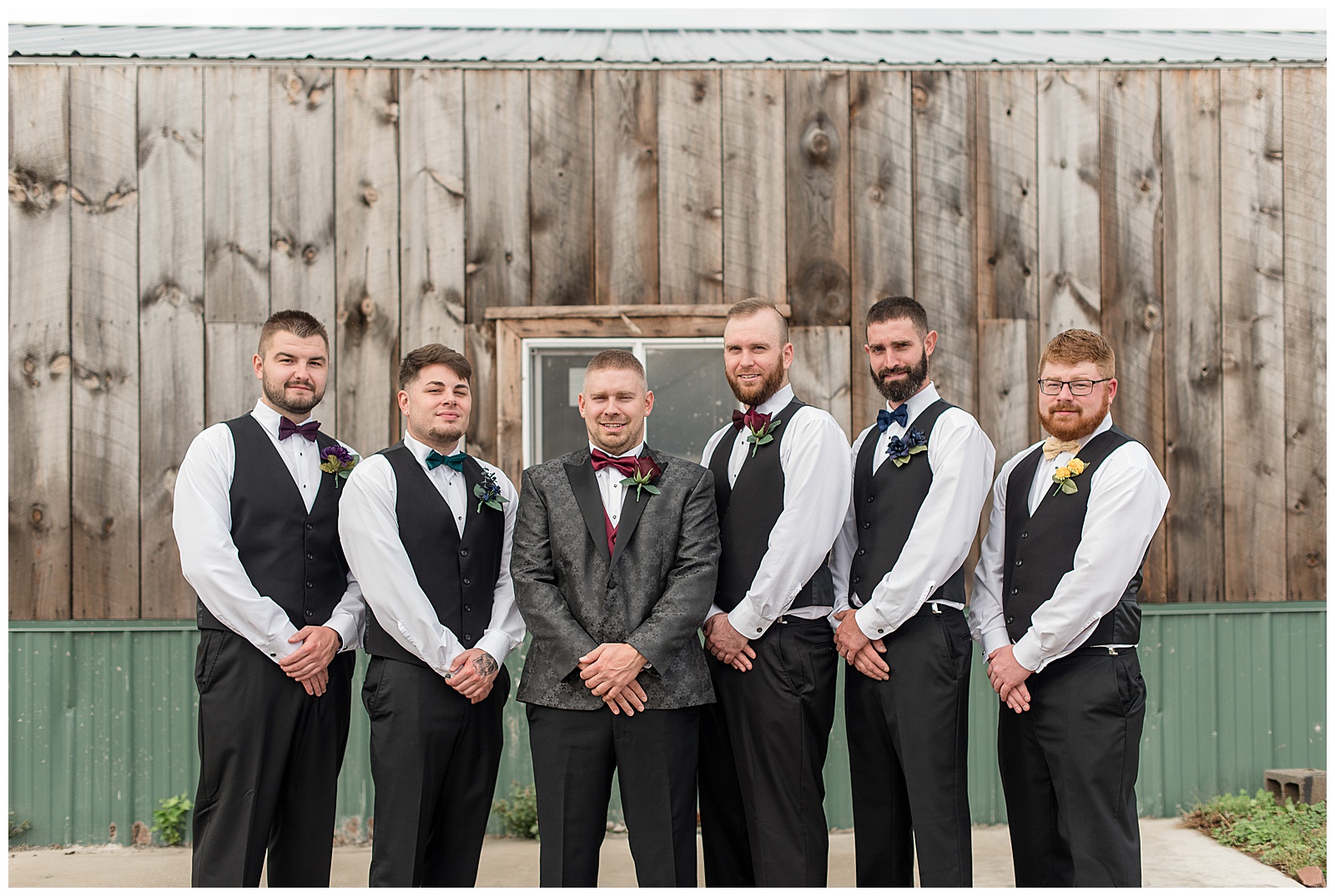 groom and his five groomsmen with their hands folded in front of them by rustic barn in dover pennsylvania