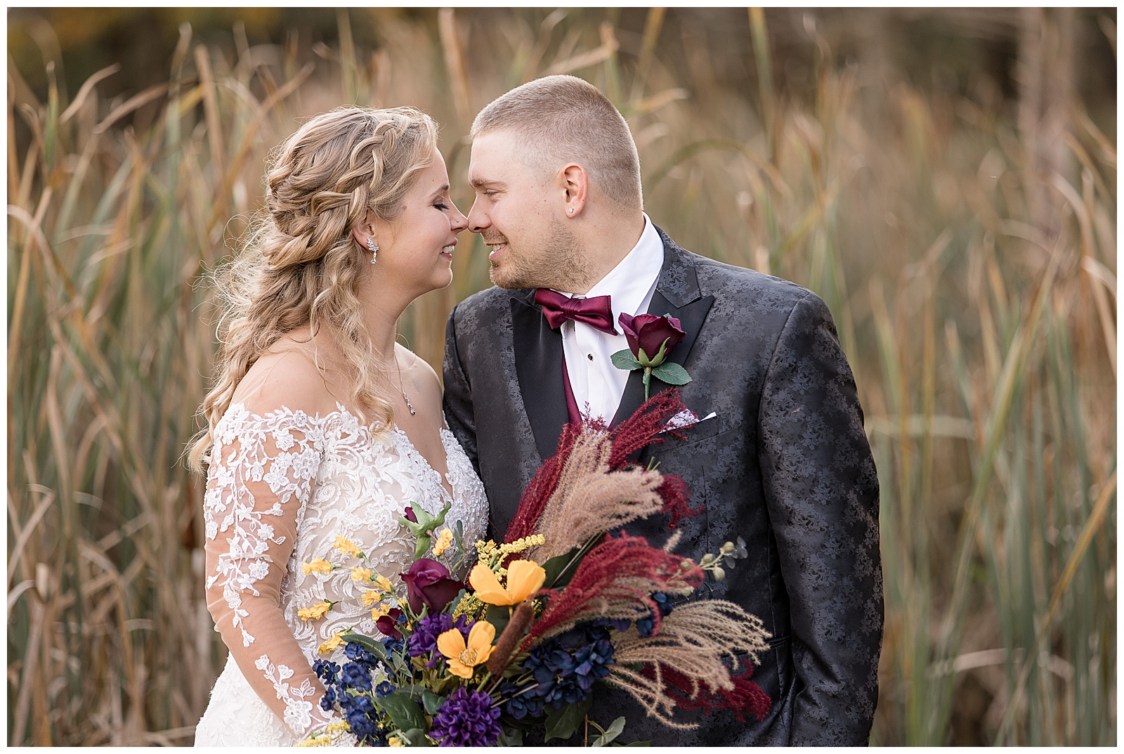 just married couple touching noses and smiling by brown corn stalks at walnut grove farms