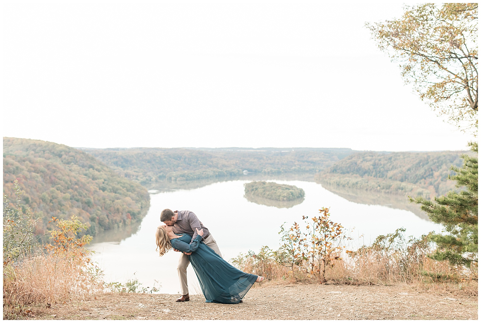 man dipping woman way back as they kiss atop pinnacle point overlook with the susquehanna river behind and below them in holtwood pennsylvania