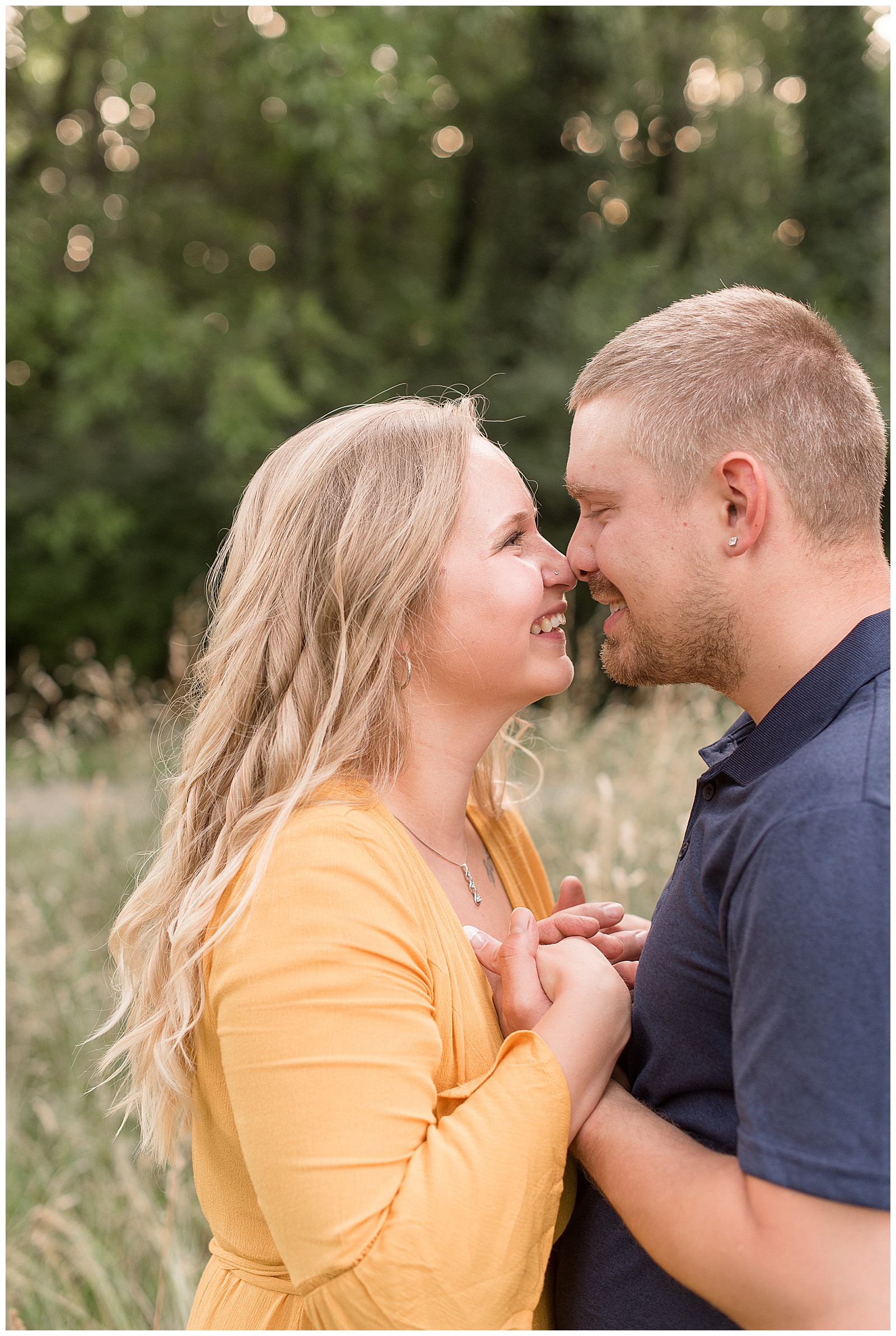 close up of engaged couple smiling as they touch noses almost kissing at manheim township park