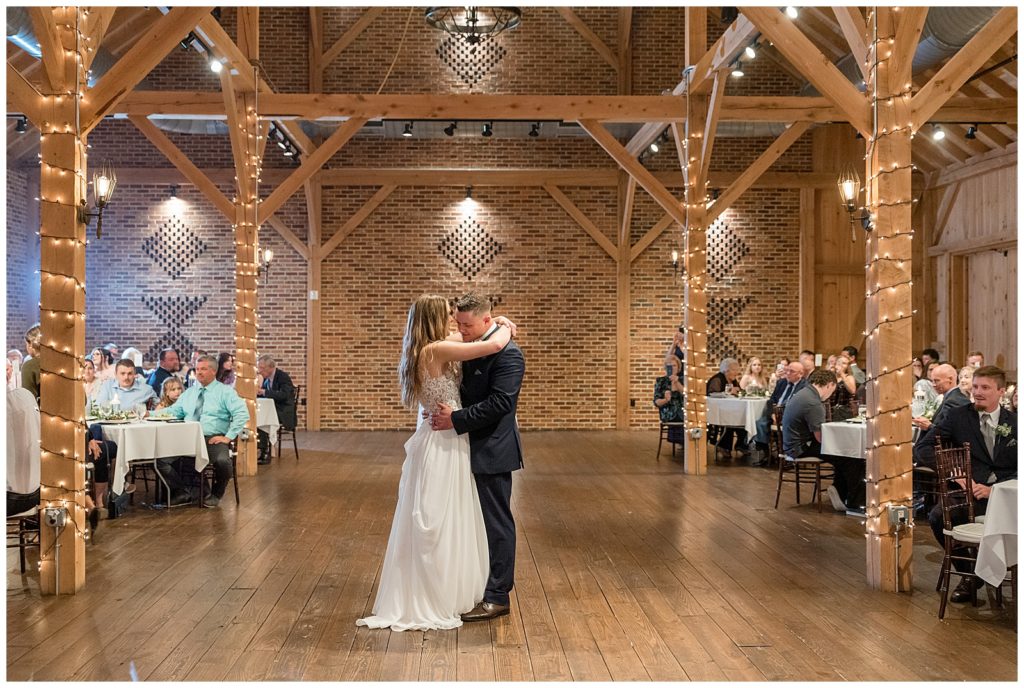 bride and groom sharing their first dance inside beautiful barn reception at brick gables in lititz pennsylvania