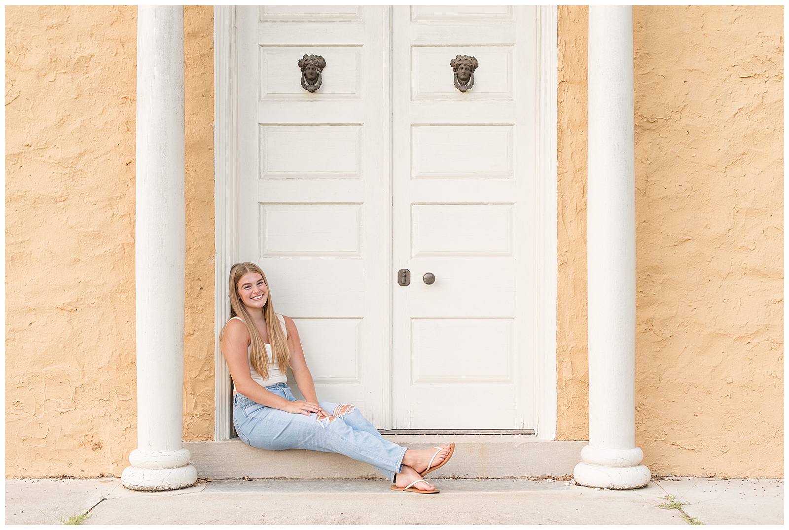senior girl sitting step to doorway with legs extended at hibernia park in coatesville, pennsylvania