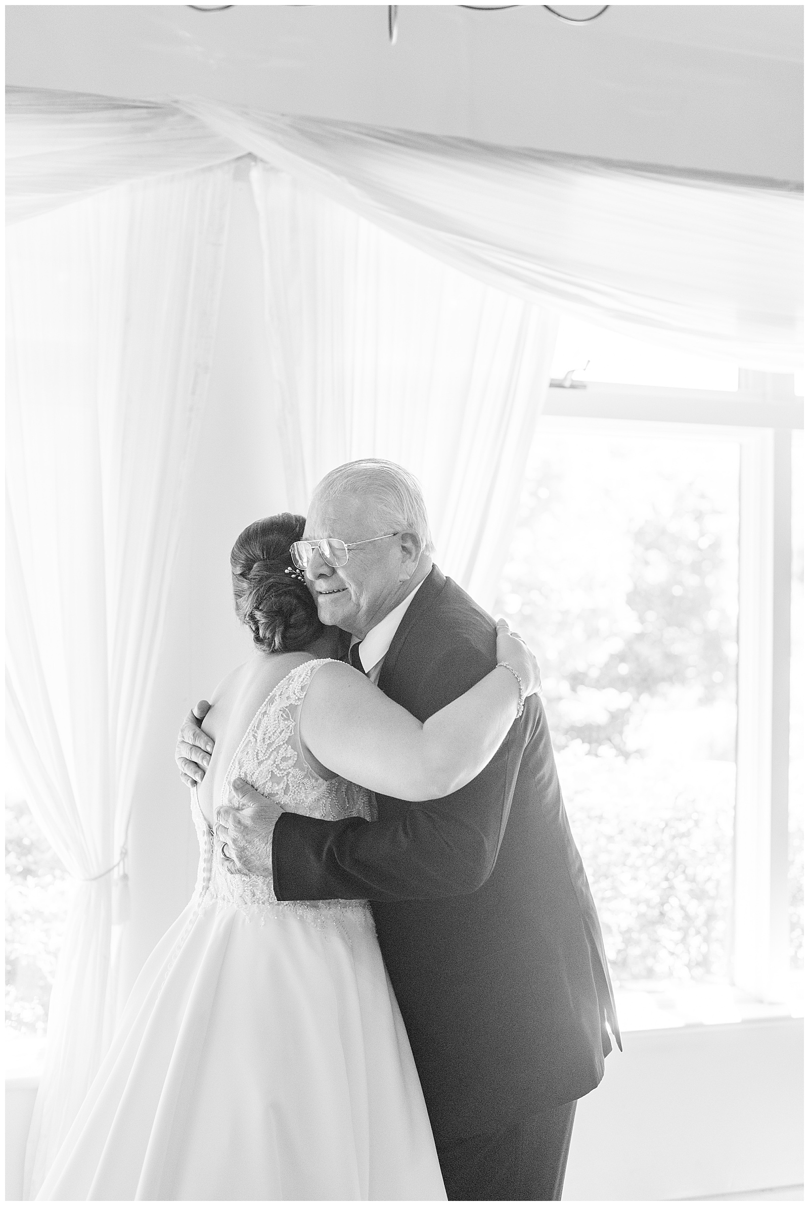 bride and her dad hugging during first look moment on wedding day at the manor at mountain view