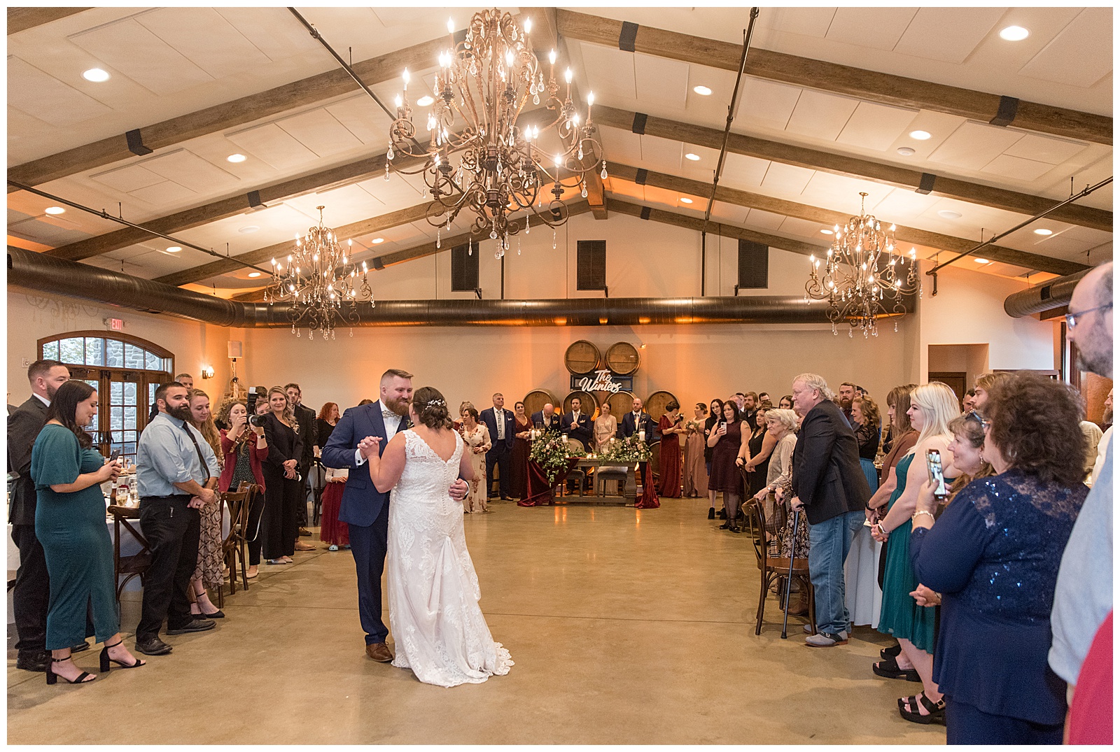 couple sharing their first dance inside beautiful wedding reception with guests watching at folino estate
