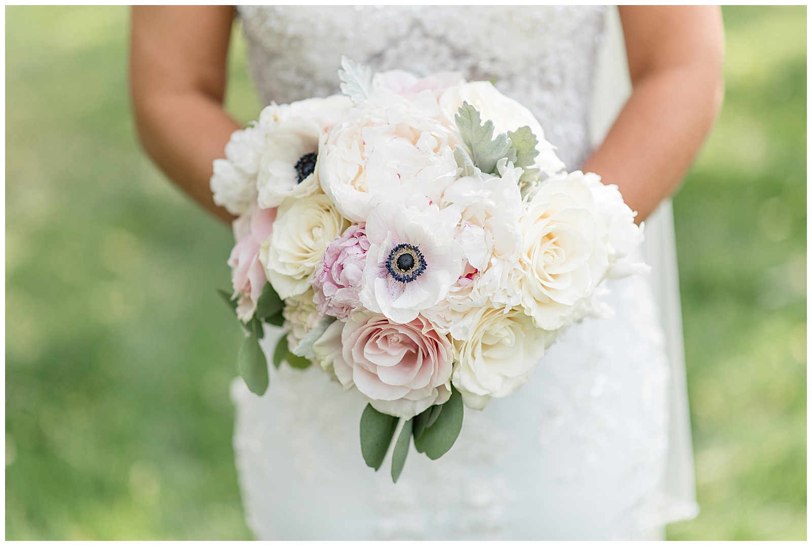 close up photo of bride's beautiful bouquet filled with pink and white roses and anenome flowers at stoltzfus homestead in intercourse pennsylvania