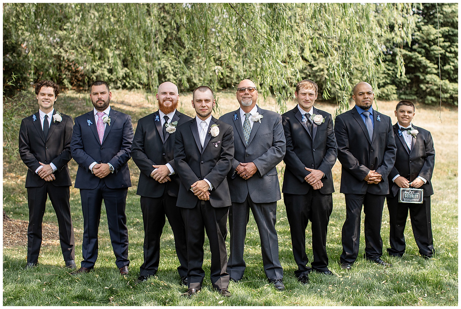 groom with his five groomsmen all standing with their hands folded in front of them by willow tree at stoltzfus homestead and gardens