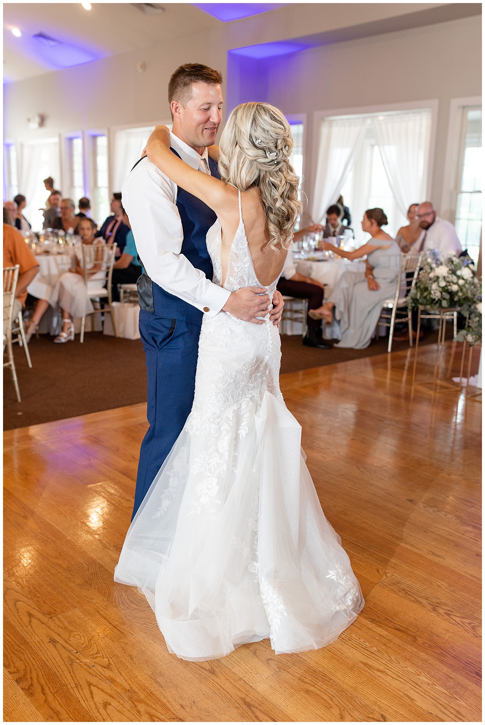 couple sharing their first dance inside reception space at the links at gettysburg as guests watch