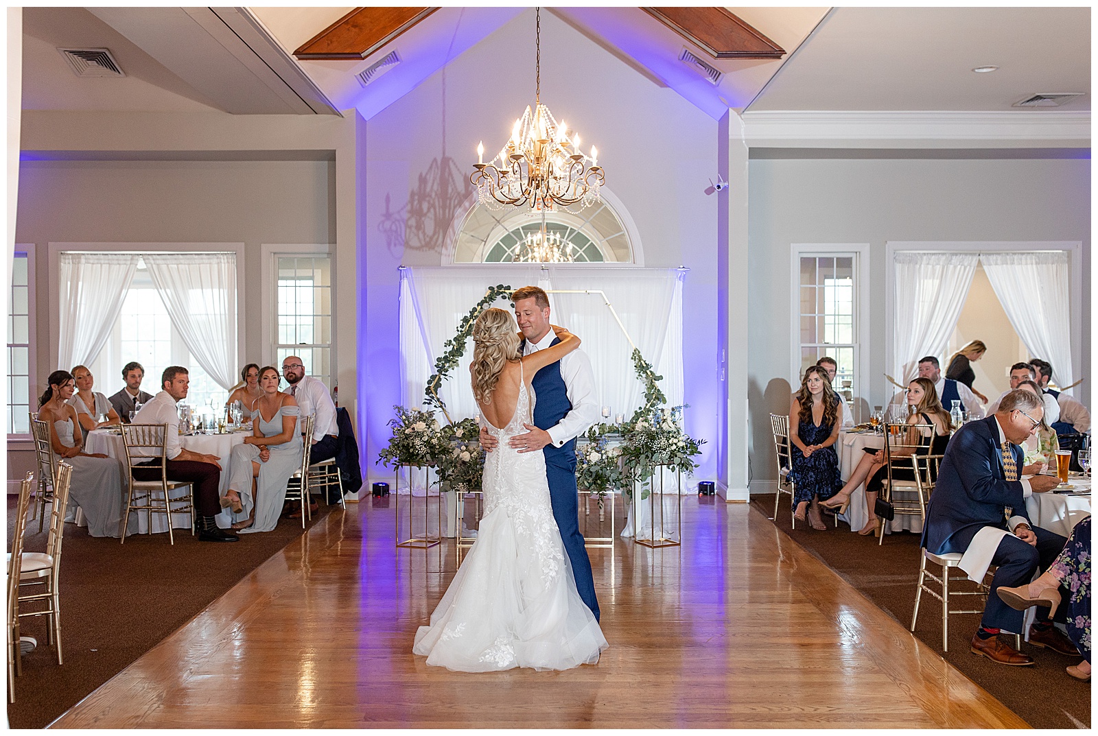 bride and groom sharing their first dance with bride's back towards camera on the dance floor under chandelier in gettysburg pa