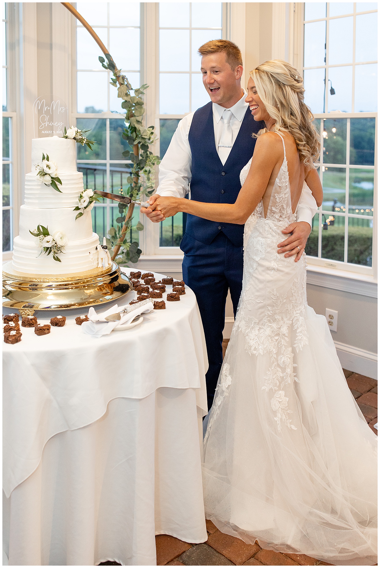 bride and groom cutting their wedding cake during their indoor reception at the links at gettysburg