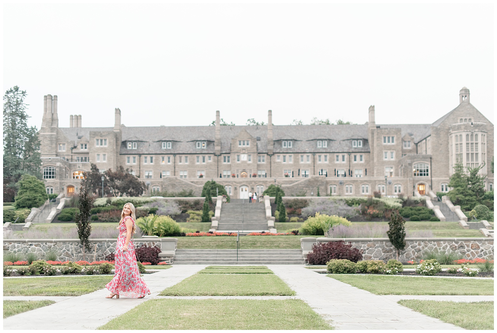 senior girl walking in front of large building on sunny summer evening for this Masonic Village Summer Senior Session