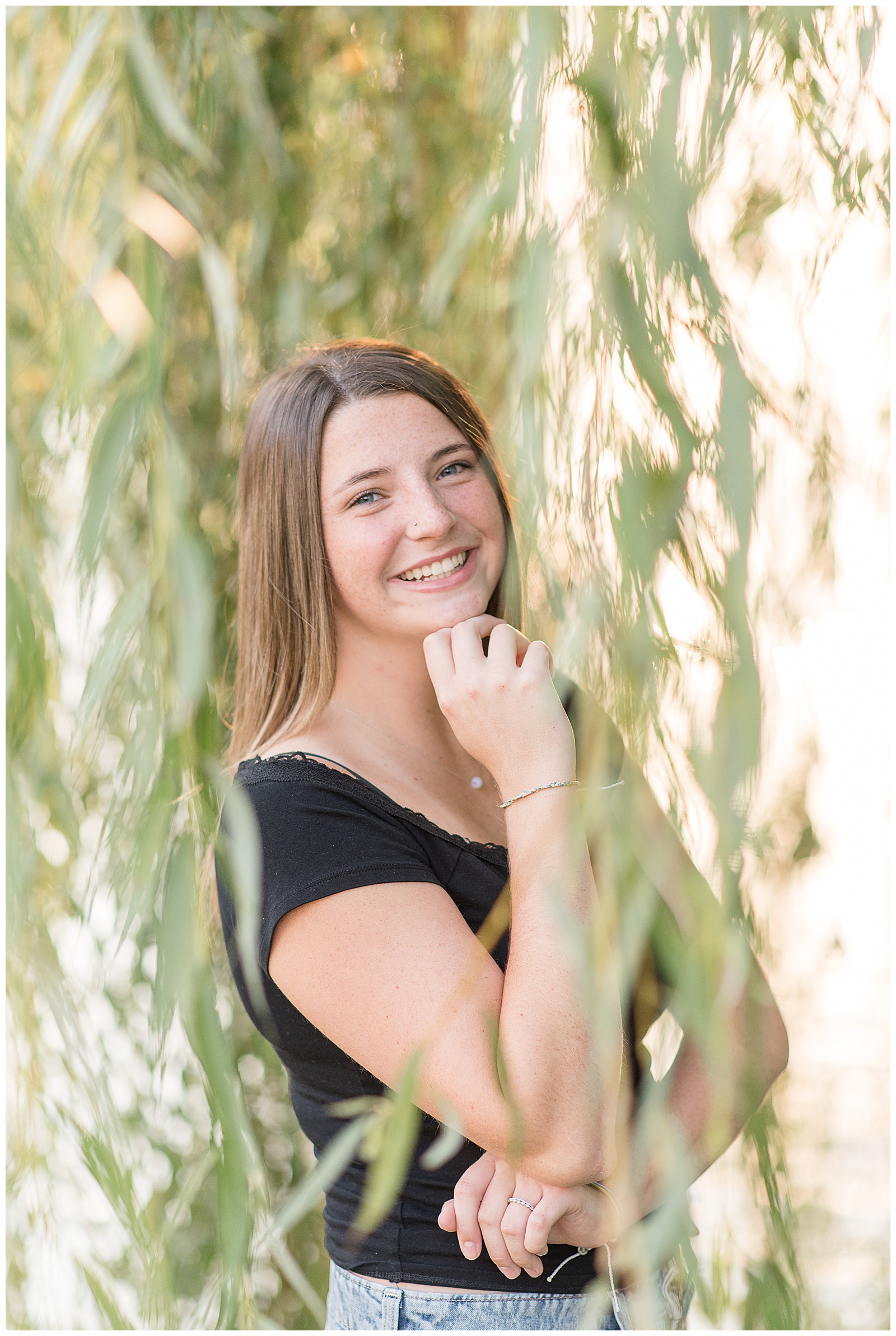senior girl in black short-sleeve shirt with right hand resting on chin for this Lancaster Senior Spokesmodel Mini Sessions in Greenfield Park