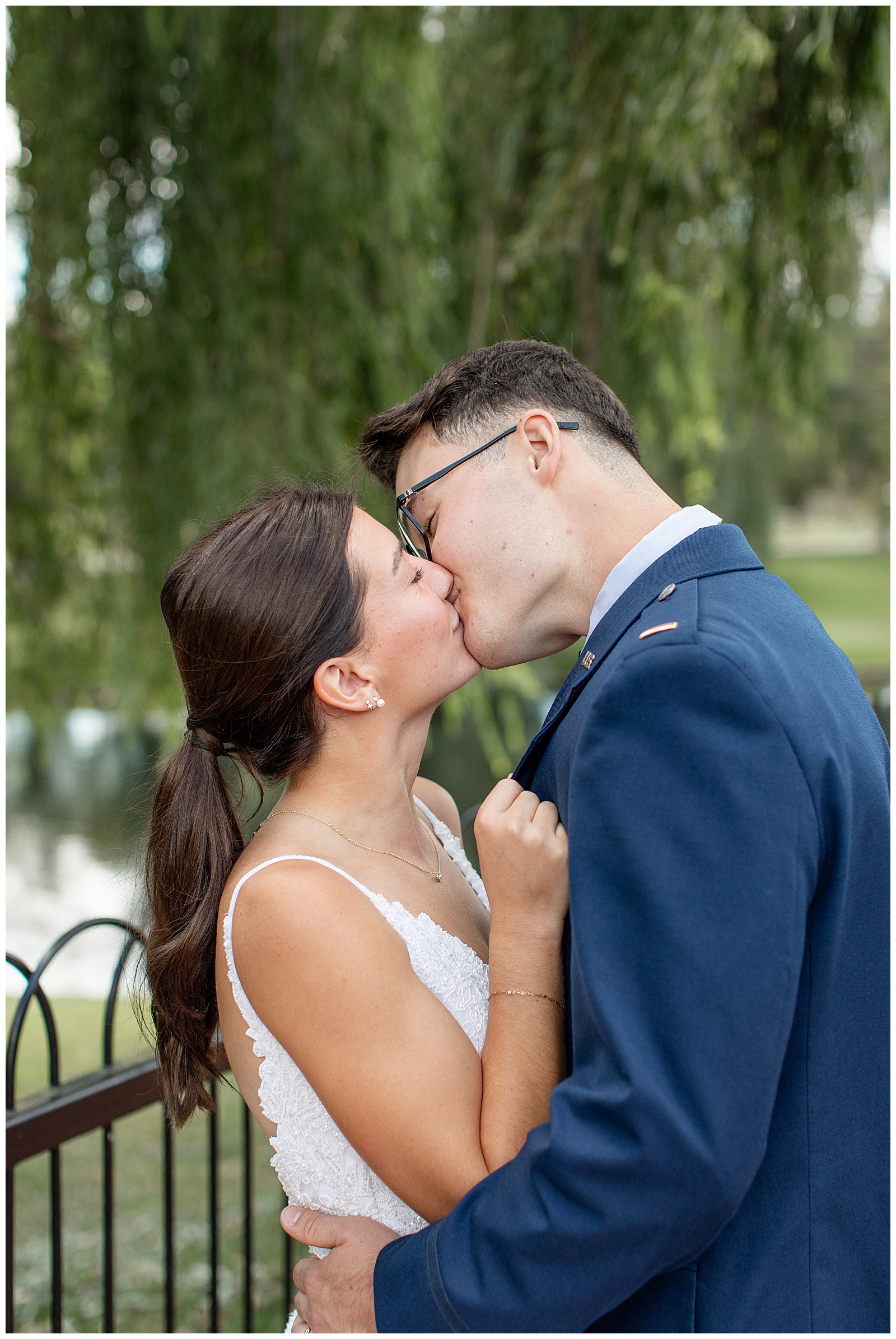 couple kissing with groom in navy blue suit and bride in sleeveless wedding gown for this Intimate Central PA Elopement