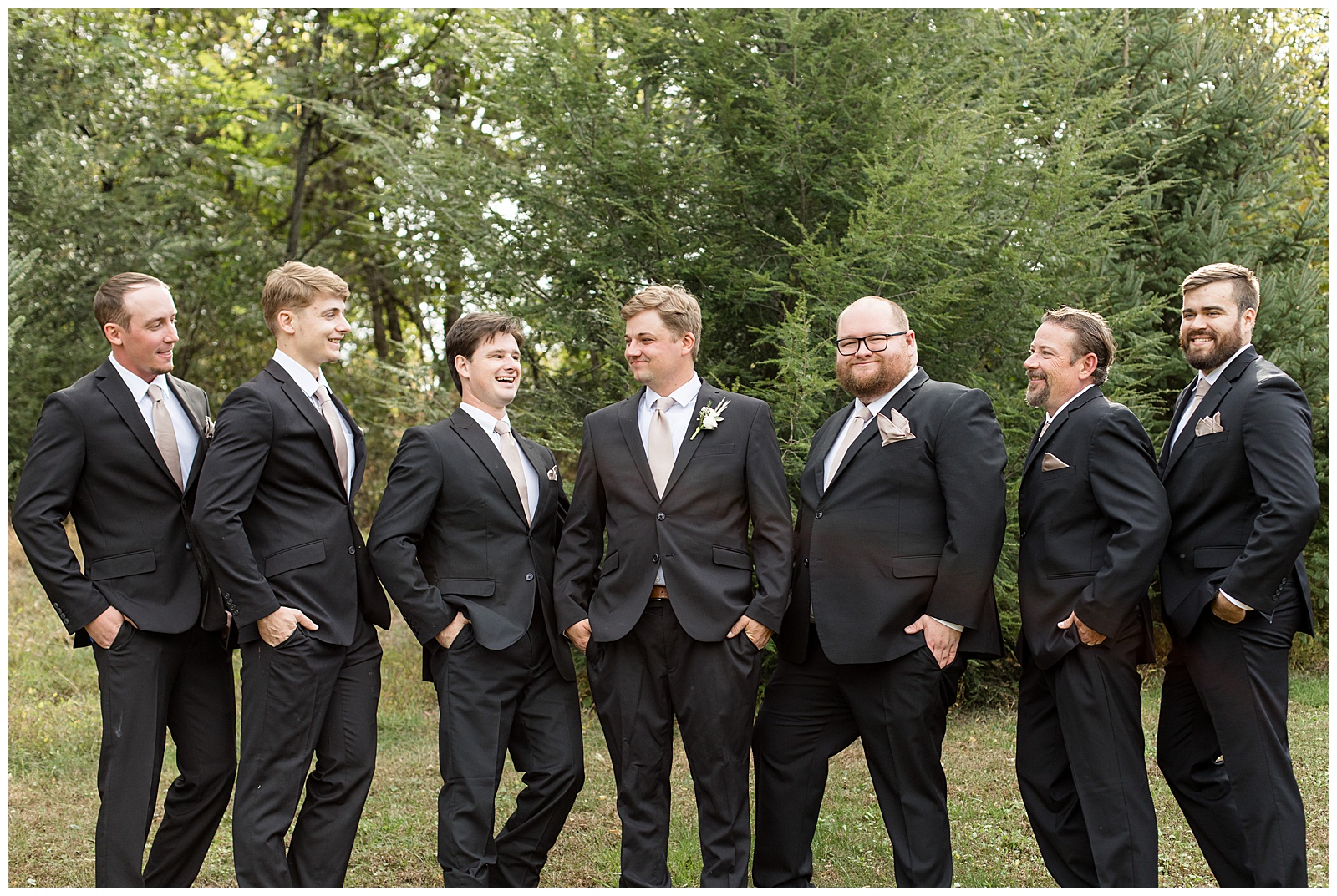 groom with his six groomsmen all in black suits and smiling for this Central PA Farm Wedding
