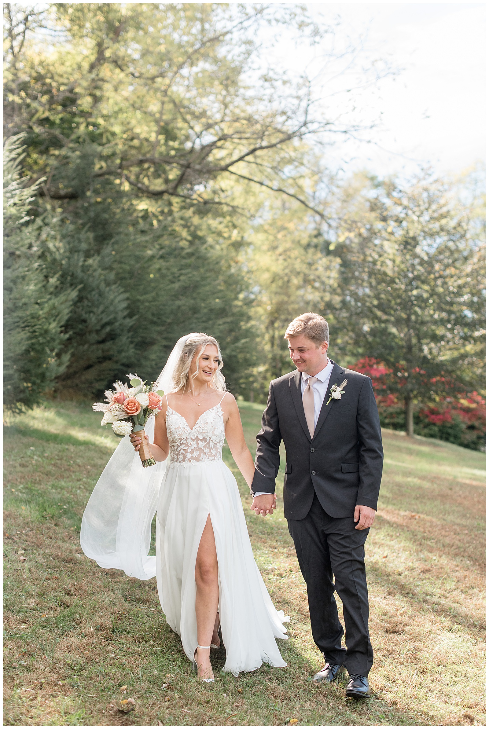 bride and groom holding hands and walking towards camera for this Central PA Farm Wedding