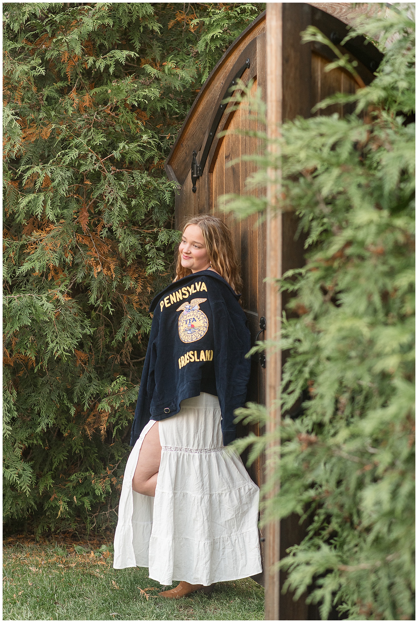 senior girl holding ffa jacket on sunny fall evening for this Stoltzfus Homestead and Gardens Senior Session