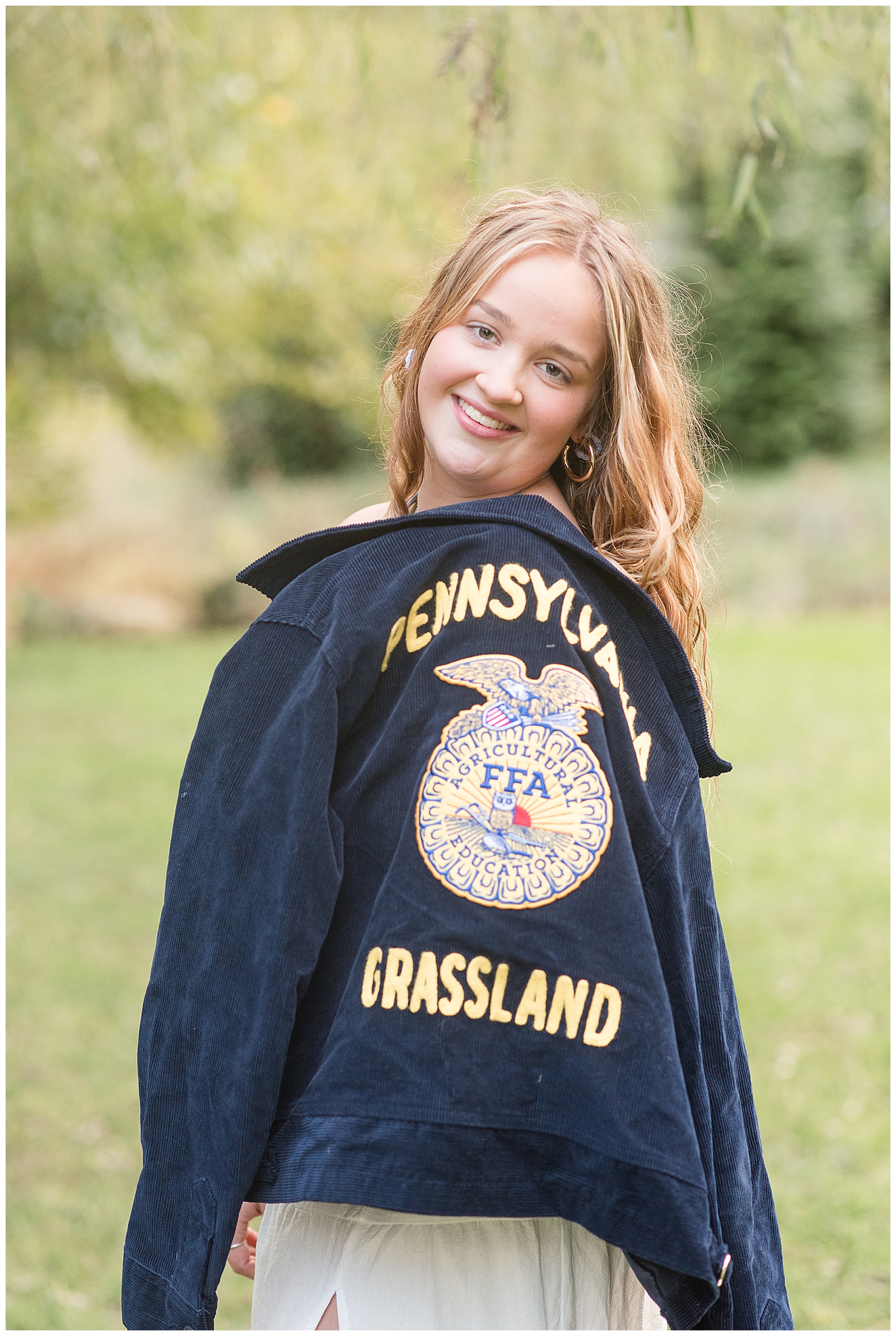 senior girl holding ffa jacket over her left shoulder for this Stoltzfus Homestead and Gardens Senior Session