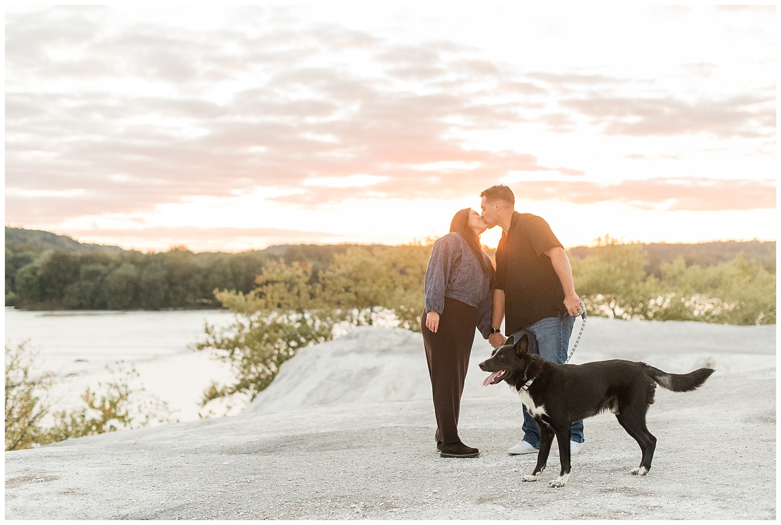 couple kissing while guy holds pup's leash for this White Cliffs of Conoy Fall Couples Session
