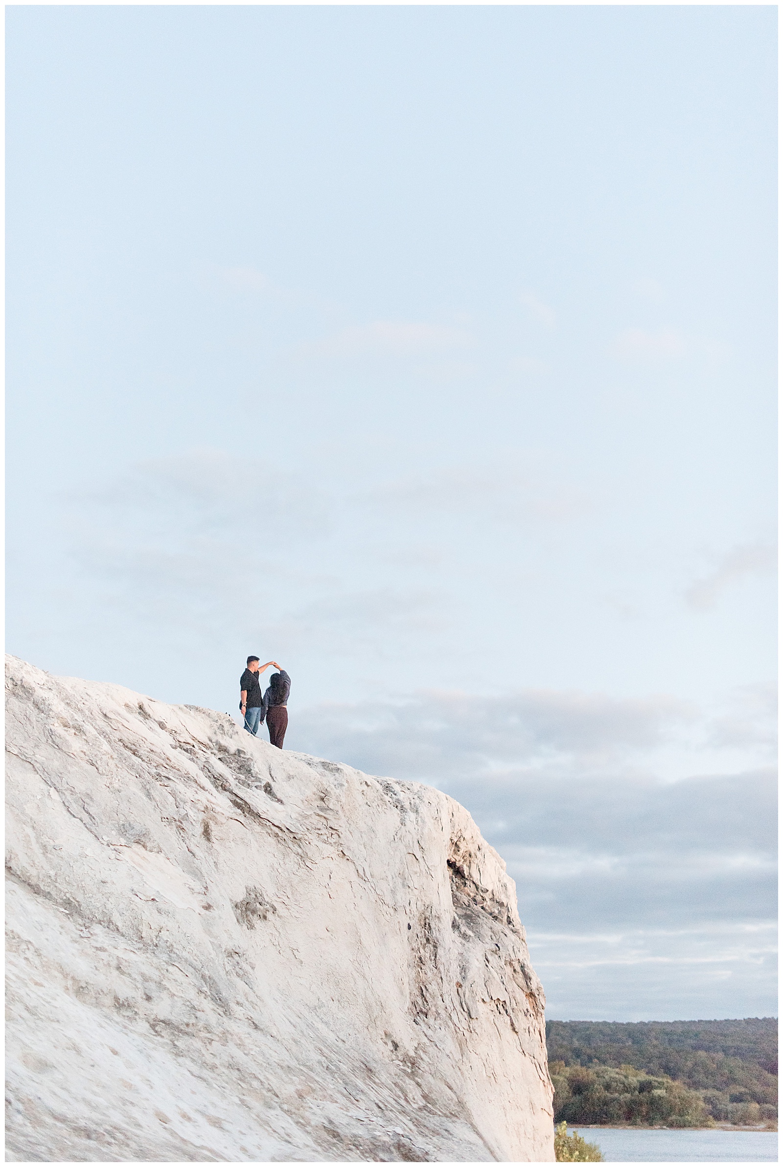 couple standing atop white mountain way off in the distance for this White Cliffs of Conoy Fall Couples Session