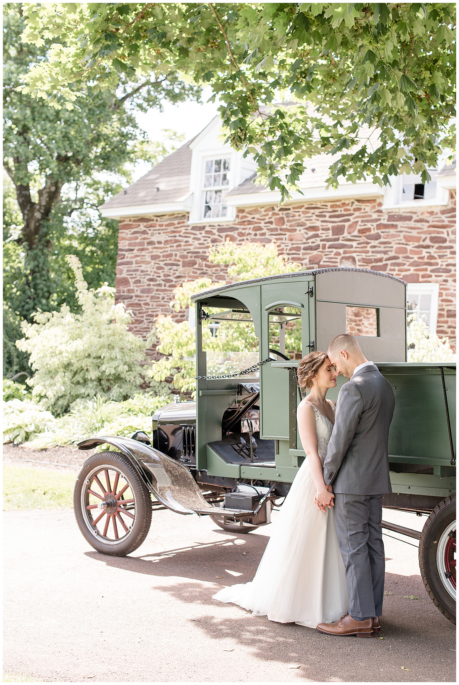 bride and groom portrait in front of old truck