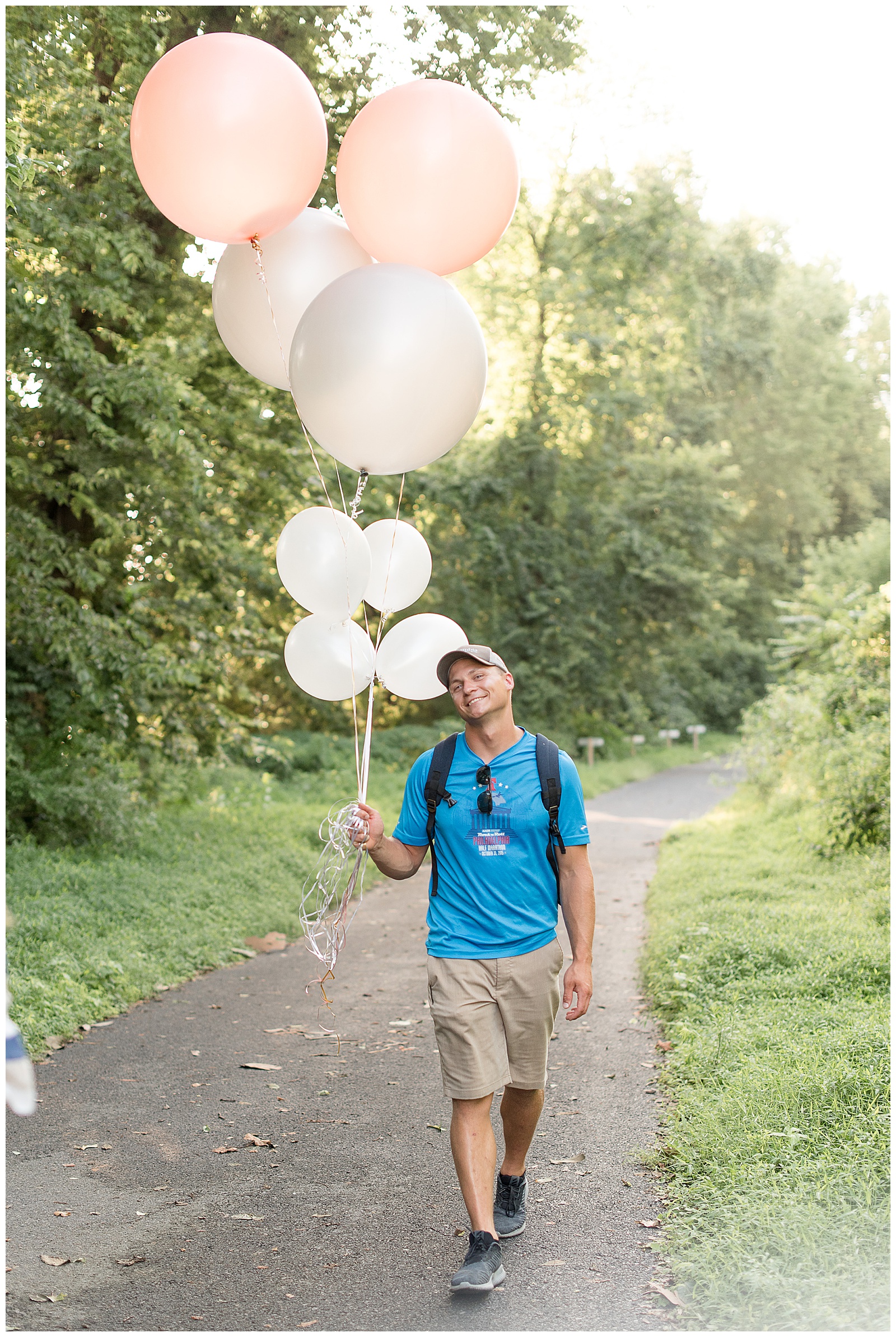 guy smiling walking with ballons