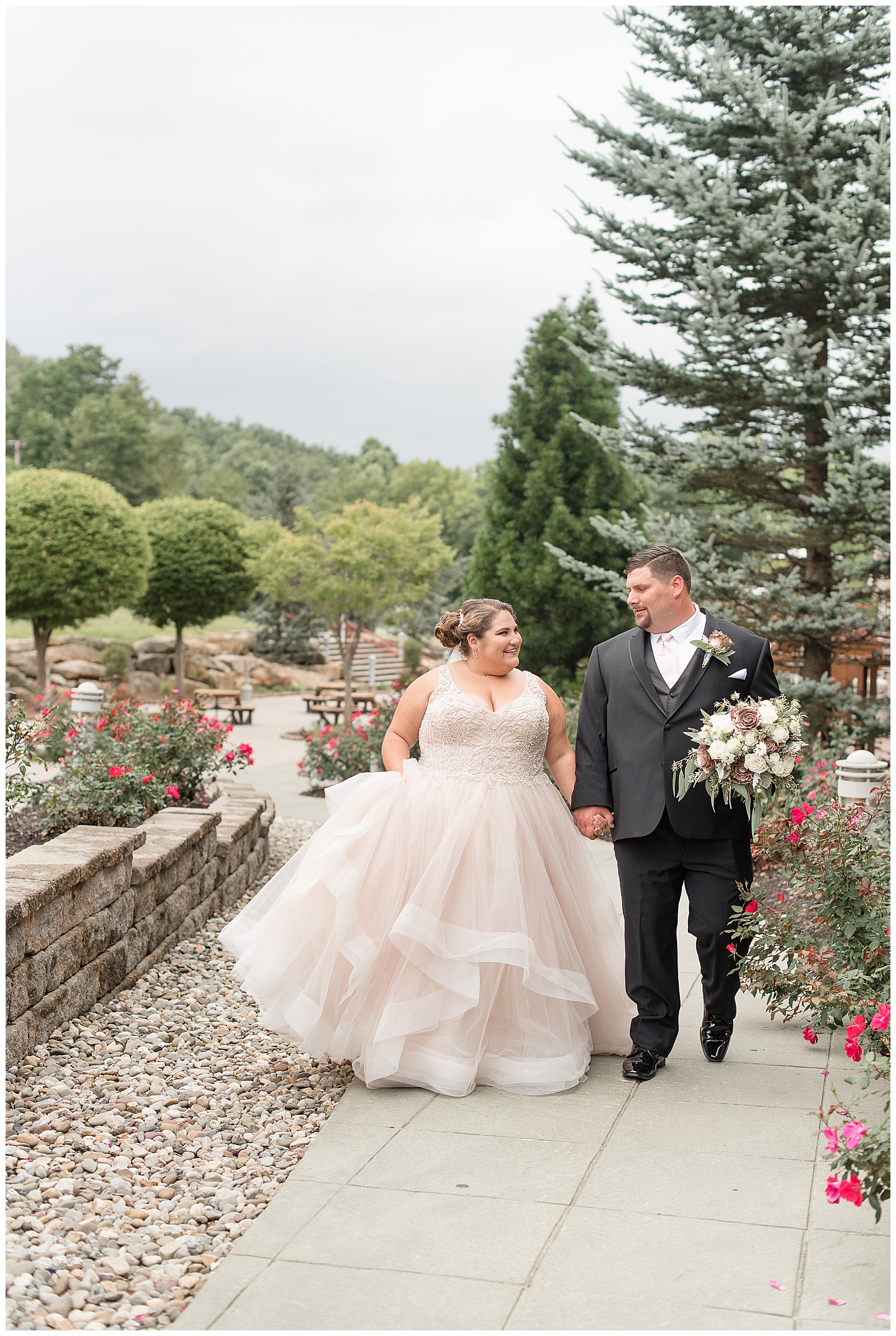 bride and groom walking hand in hand up path at Bear Creek Mountain Resort