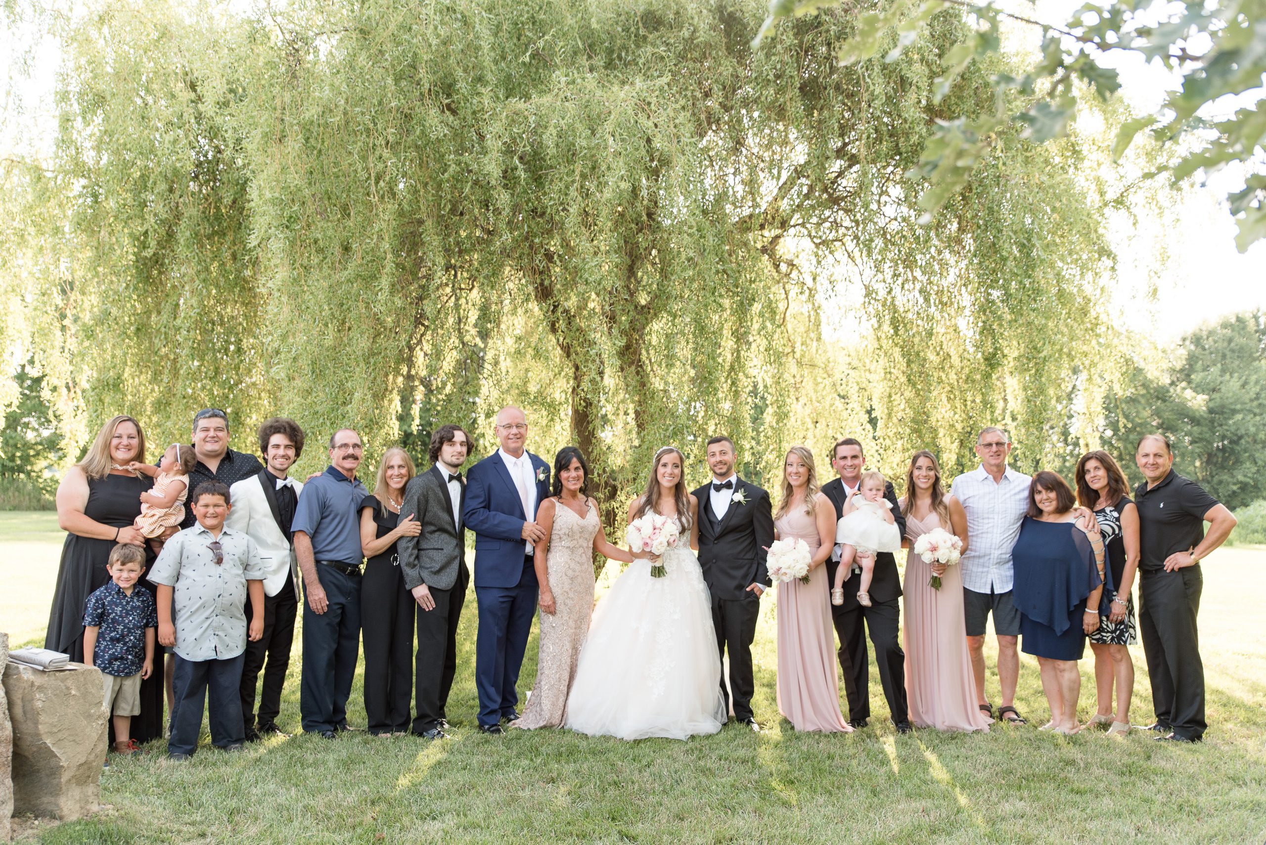 Extended family formal in front of willow tree