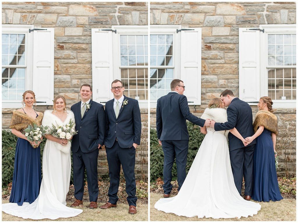 bride and groom surrounded by bridal party as they stand close together outside historic gray stone building with white shutters