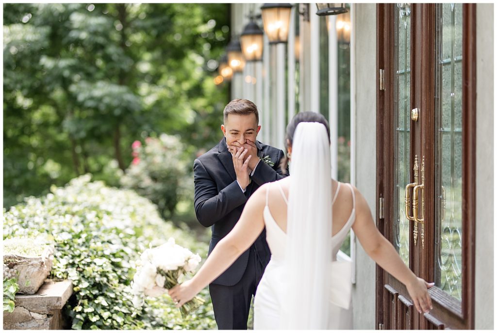 groom reacting with his hands over his mouth during first look with his bride at cameron estate inn