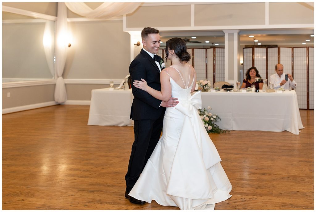 bride and groom sharing their first dance during indoor reception at cameron estate inn