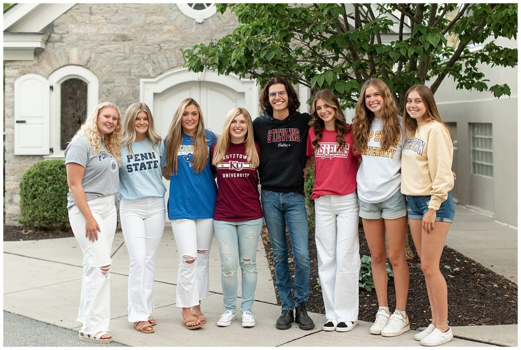 eight senior spokesmodels for the class of 2022 wearing college t-shirts with arms around each other in lancaster pennsylvania