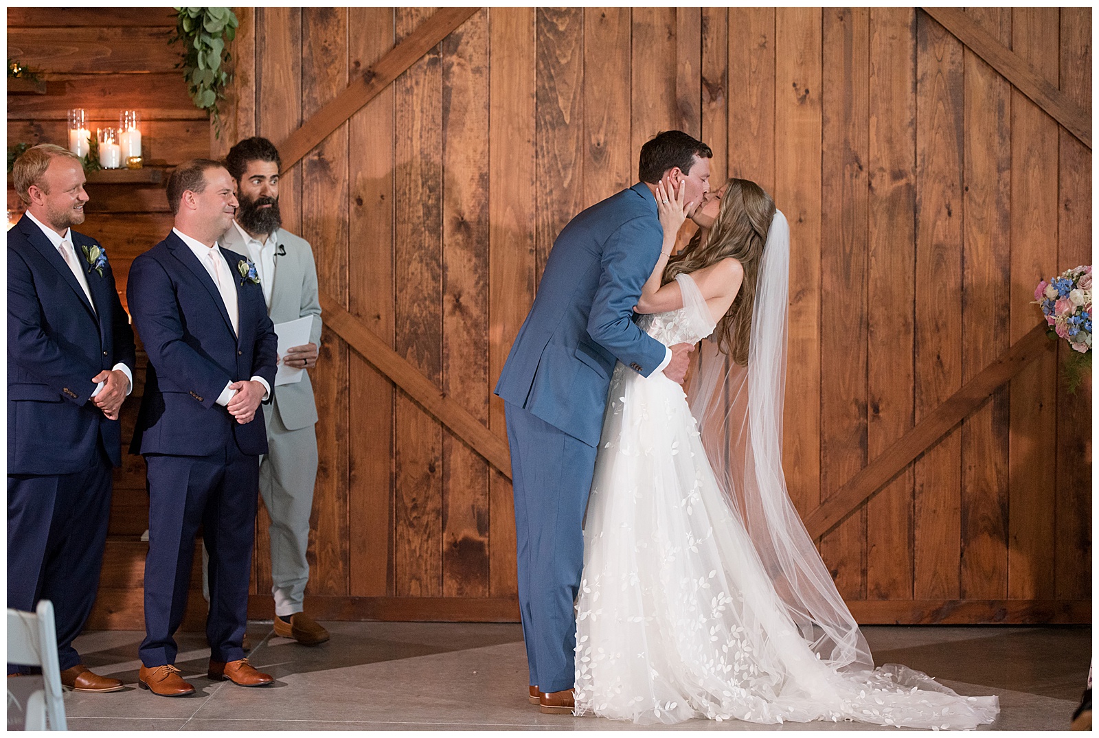 couple sharing their first kiss inside barn wedding venue in lancaster county 